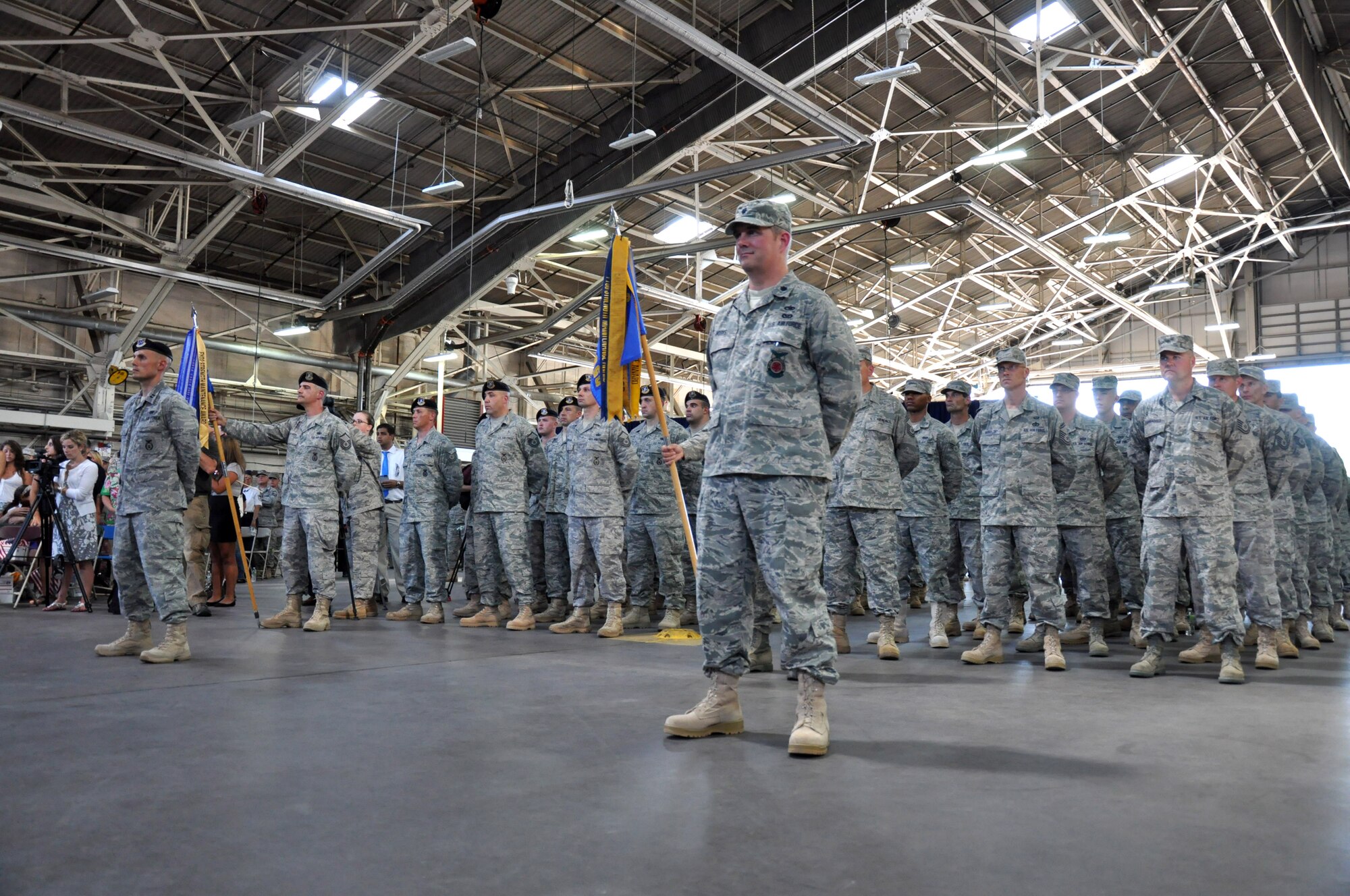 Lt. Col. James Works (front right), commander of the 103rd Civil Engineer Squadron and Capt. Andrew Nemeth (far left front), who will command the  deployed 103rd Security Forces Squadron, stand at ease as their respective units stand behind them during a Send-Off Ceremony at Bradley Air National Guard Base, East Granby, Conn. July 6, 2011. The two commanders will lead their troops in overseas contingency operations in support of Operation Enduring Freedom. (U.S. Air Force photo by Army 2nd  Lt. Emily Hein)
