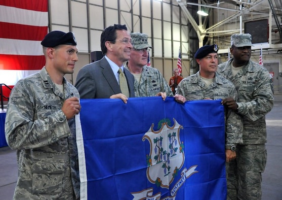 Gov. Dannel P. Malloy poses with Capt. Andrew Nemeth, Maj. Gen. Thaddeus Martin, Master Sgt. Daniel Judd and State Command Chief Master Sgt. John Carter in the main hangar at Bradley Air National Guard Base, East Granby, Conn. July 6, 2011. The Connecticut state flag was presented to Capt. Nemeth, who will command the deployed security forces troops, following a formal Send Off Ceremony held in honor of members of the 103rd Security Forces and 103rd Civil Engineer Squadrons who have since deployed to Afghanistan. (U.S. Air Force photo by Army 2nd Lt. Emily Hein)