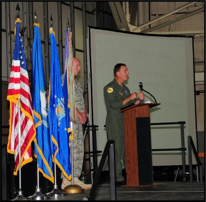 Wing Command Chief Master Sgt. Edward Gould looks on as Col. Frank Detorie, 103rd Airlift Wing commander, addresses Flying Yankee members, family, friends and guests gathered to recognize 2010’s outstanding performers June 4, 2011, in the main hangar at Bradley Air National Guard Base, East Granby, Conn. (U.S. Air Force photo by Airman 1st Class Emmanuel Santiago)