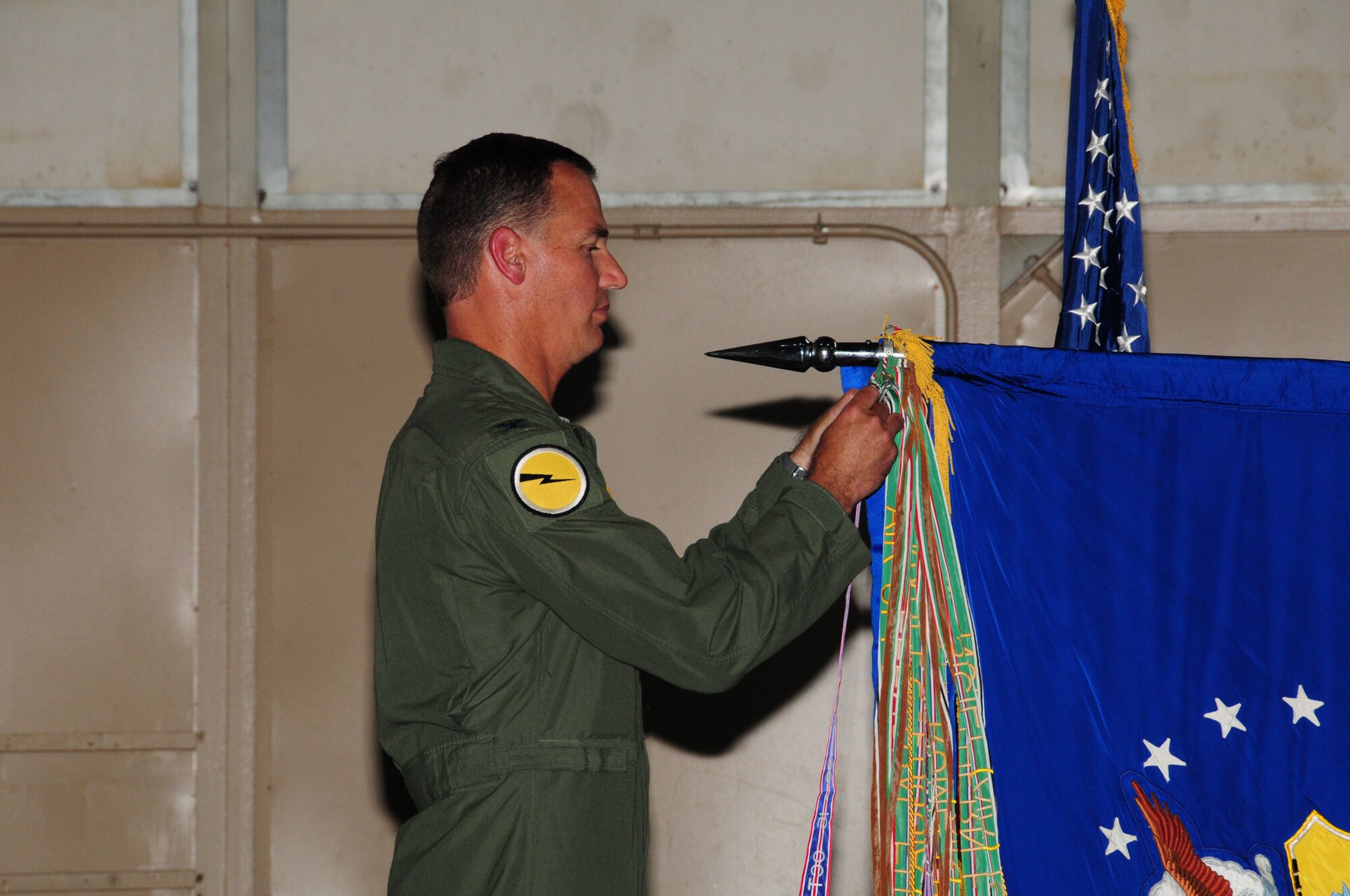 Col. Frank Detorie, 103rd Airlift Wing commander, pins the unit flag with the Air Force Outstanding Unit of the Year Award streamer during the annual awards ceremony at Bradley Air National Guard Base, East Granby, Conn. June 4, 2011. (U.S. Air Force photo by Airman 1st Class Emmanuel Santiago)