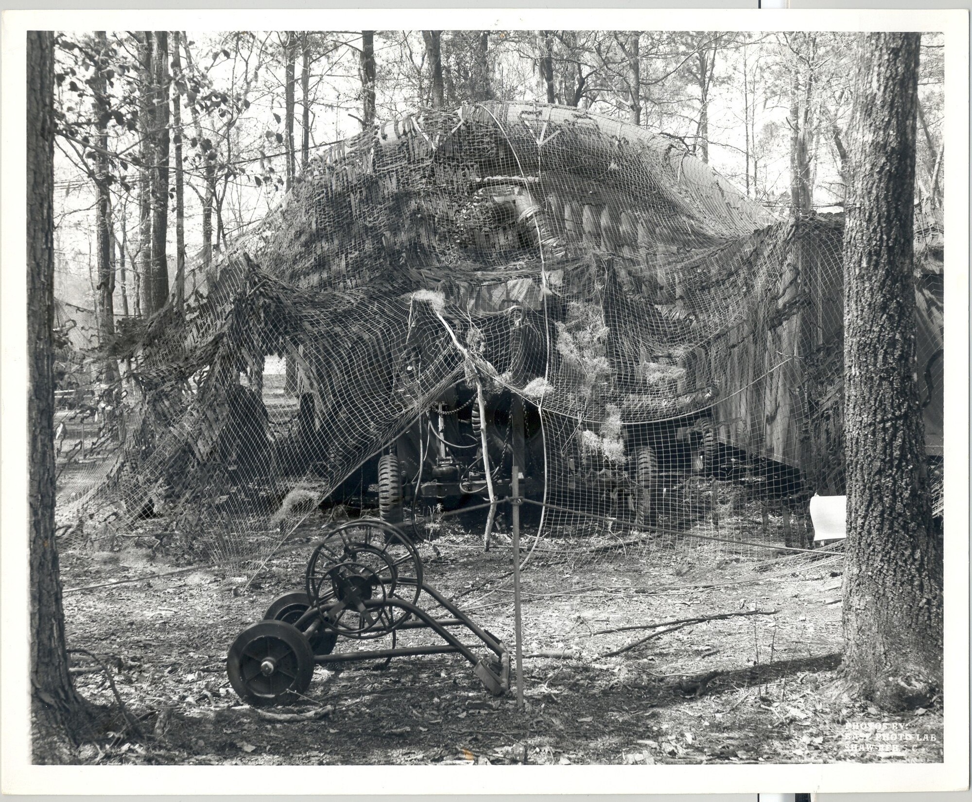 Members from the 682nd Air Support Operations Squadron take cover under some netting at Solid Shield circa 1976. The 682nd ASOS has been located on Shaw Air Force Base, S.C. since 1971. (U.S. Air Force photo)