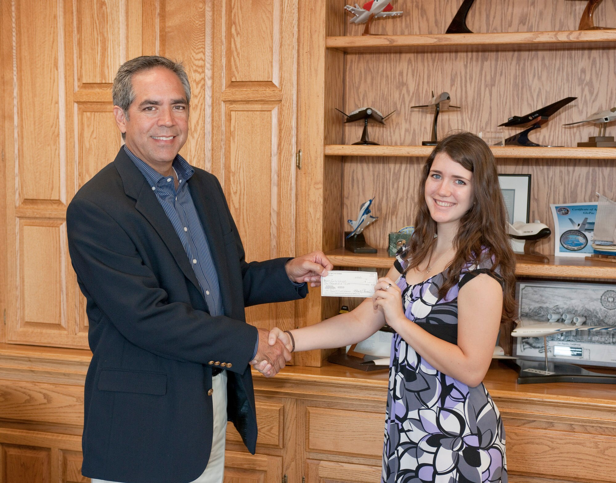 NASA Dryden Flight Research Center director David McBride congratulates Emily Wright, recipient of the 2011 NASA Dryden Employee Exchange Council Scholarship. (NASA photo by Tom Tschida)