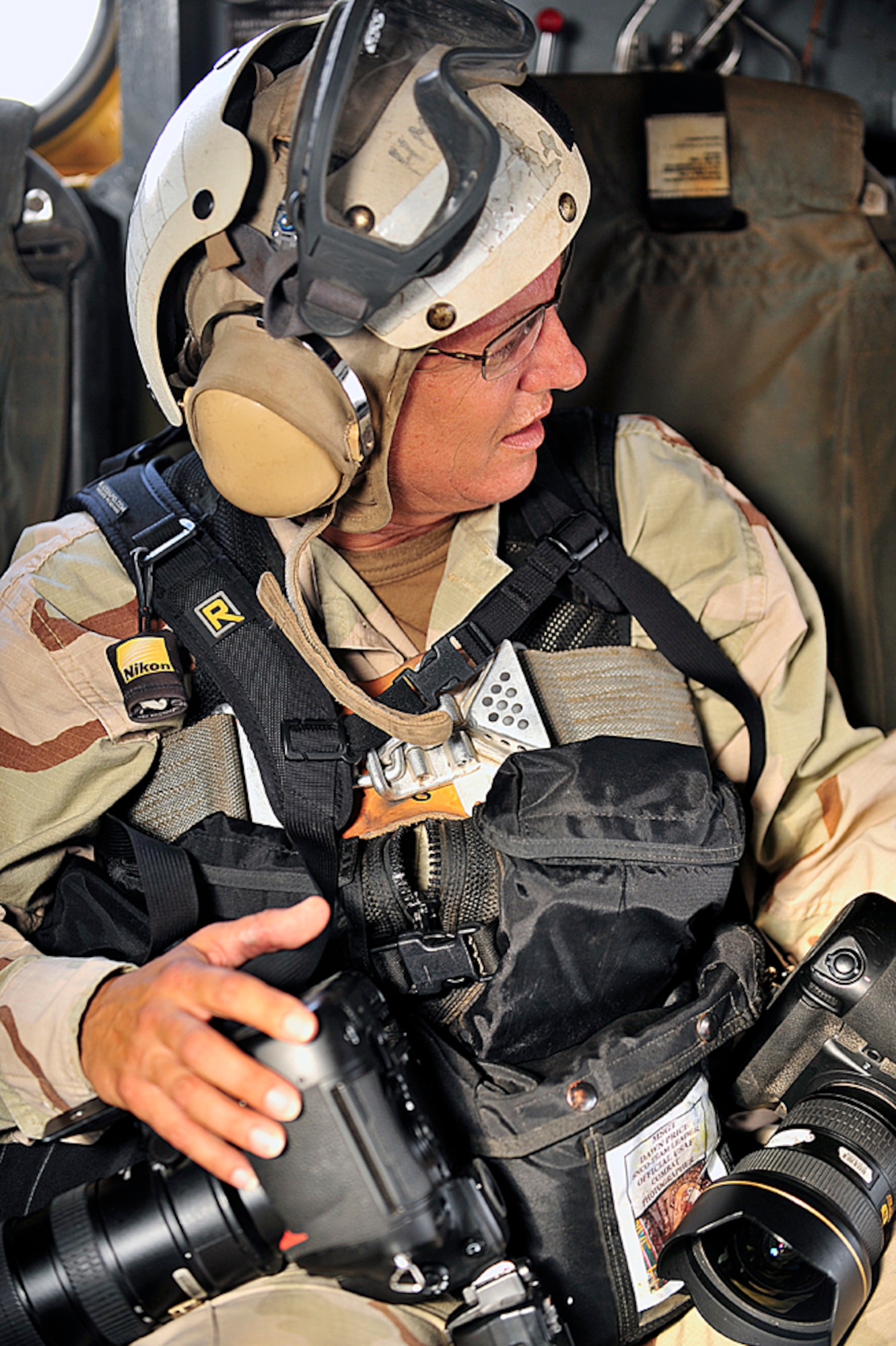 Combat Cameraman Master Sgt. Dawn Price aboard a U.S. Marine Corps MH-53 helicopter over the Gulf of Tadjora between Djibouti and Yemen. (U.S. Army Photo/Spec. Michelle Lawrence)