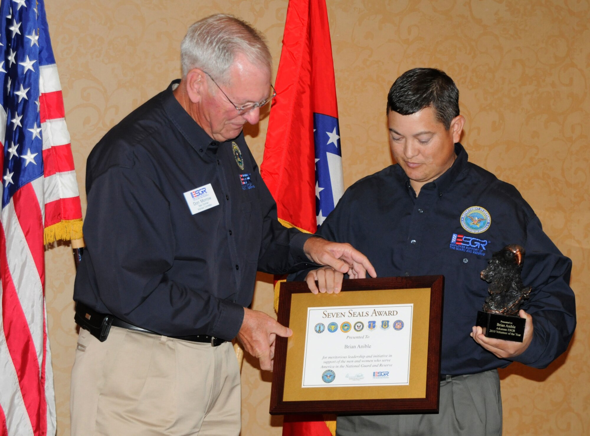 Master Sgt. Brian Anible of the 188th Aircraft Maintenance Squadron, right, accepts the Employer Support of the Guard and Reserve Volunteer of the Year award for the state of Arkansas from Maj. Gen. (Ret.) Don Morrow, Arkansas ESGR chair and former adjutant general for the Arkansas National Guard, at the ESGR Annual Employer Awards Luncheon held July 21 at the Embassy Suites Hotel in Hot Springs, Ark. (U.S. Air Force photo by Lt. Col. Keith Moore/Arkansas National Guard public affairs)