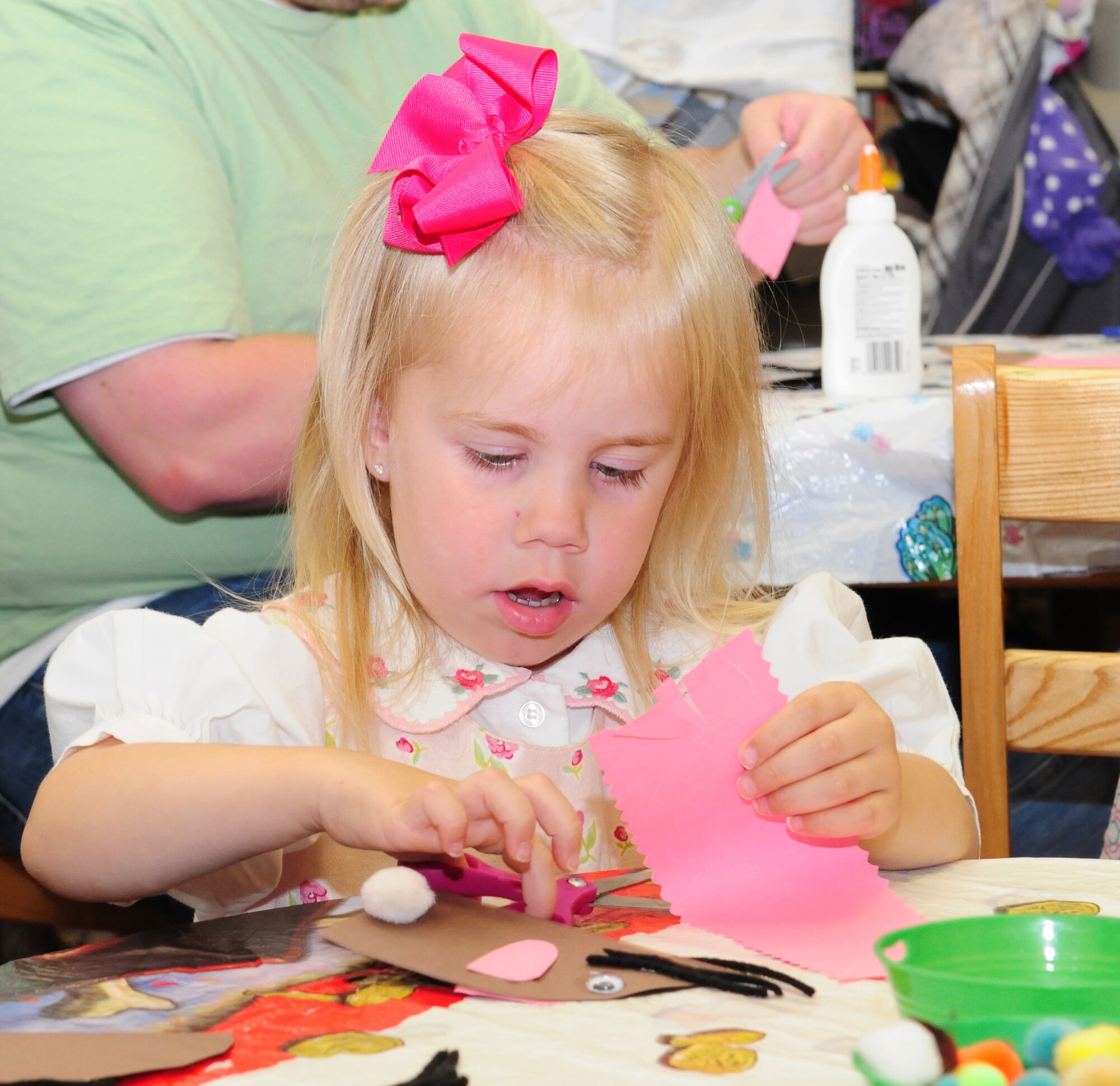 RAF MILDENHALL, England -- Hope Smith, 3, cuts 'mouse ears' out of paper during the craft and story time event at the base library here Aug. 10, 2011. Hope's parents, Staff Sgt. Mike Smith, 100th Operations Support Squadron, and Camey Smith, brought her and her older brother, Ethan, 4, to take part in the crafts and story time, which takes place every Wednesday from 10:30 to 11:15 a.m. (U.S. Air Force photo/Karen Abeyasekere)