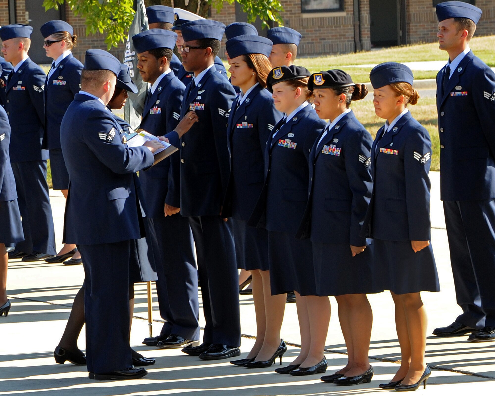 Students attending Airmen Leadership School receive their first official inspection here Aug. 1. The ALS mission is to prepare Senior Airmen to be professional, warfighting Airmen who can supervise and lead Air Force work teams to support the employment of air, space, and cyberspace power. (U.S. Air Force photo/Senior Airman Laura Turner)