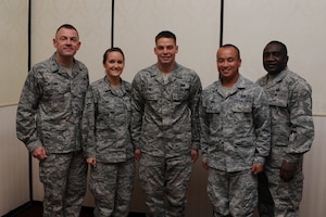 Col. Richard McComb (left) and Chief Master Sgt. Thomas Jackson recognize  Airmen 1st Class Krista Kerry, A1C Gabriel Lazurka and A1C Michael Ang as Diamond Sharp award winners during a ceremony at the Charleston Club Aug. 9. Diamond Sharp awardees are Airmen chosen by their first sergeants for their excellent performance. McComb is the Joint Base Charleston commander, Jackson is the 628th Communications Squadron superintendent, Kerry is from the 628th Logistics Readiness Squadron, Lazurka is from the 628th Comptroller Squadron and Ang is from the 628th Civil Engineer Squadron. Also receiving the Diamond Sharp award but not pictured was Senior Airman Johnny Scott from the 628th Contracting Squadron. (U.S. Air Force photo/Staff Sgt. Nicole Mickle)


