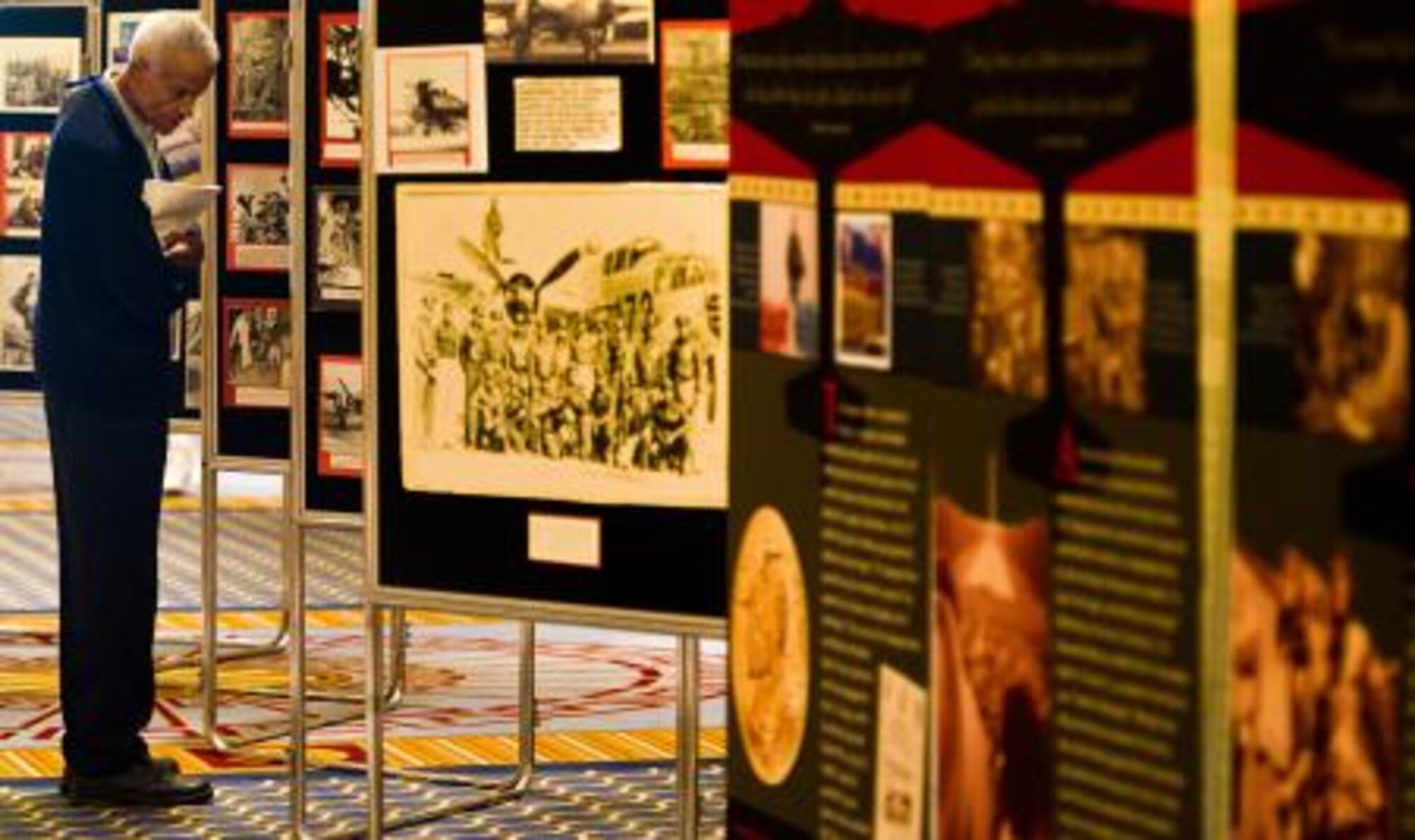 Retired Flight Officer Donald Jackson looks at photos from his old unit the 477th Bombardment Group during the 40th Tuskegee Airmen national convention Aug. 4, 2011, at Gaylord National Hotel, Md. The convention honors African-American aviation pioneers with historic displays, Tuskegee discussion panels, and guest speakers. (U.S. Air Force photo/Staff Sgt. Jonathan Snyder)
