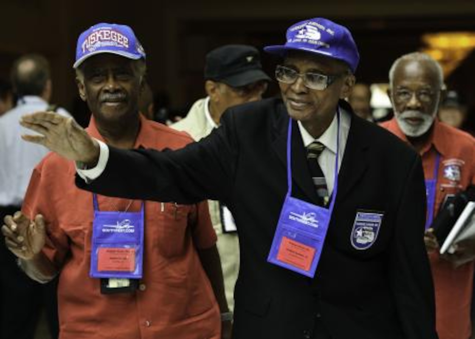 Tuskegee Airmen William Samber Sr. and James Cooper, wave in appreciation at the 40th National Tuskegee Airmen Convention Aug. 5, at the Gaylord National Hotel, Md. People gathered and clapped in appreciation to prior and current military members. (U.S. Air Force photo/Senior Airman Erik Cardenas)