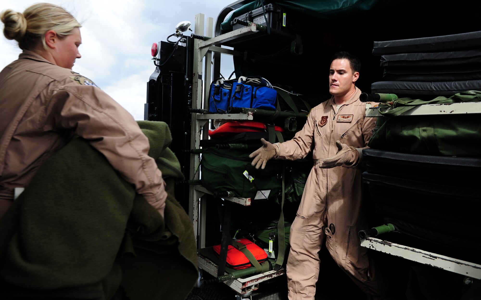 U.S. Air Force 1st Lt. Mackenzie Johnson and Staff Sgt Jordan Piper, 10th Expeditionary Aeromedical Evacuation Flight, unload medical equipment from a KC-135 Stratotanker to a hi-lift after patients arrive at Ramstein Air Base, Germany, Aug. 8, 2011. The 10th EAEF received a high-lift from the 721st Aerial Port Squadron which enabled them to be more self-sufficient while transporting patients. (U.S. Air Force Photo by Airman 1st Class Brea Miller