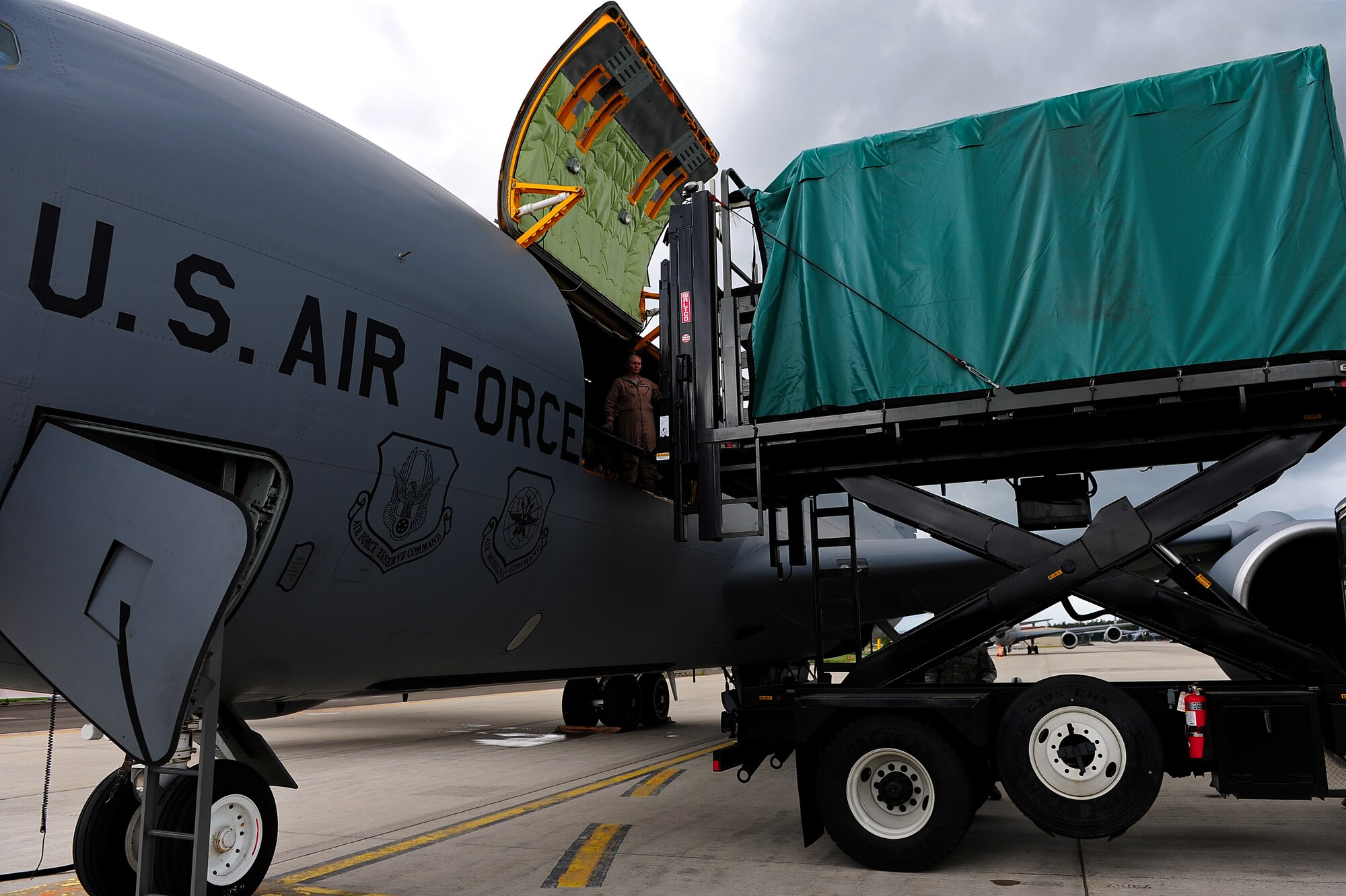 U.S. Air Force service members from the 10th Expeditionary Aeromedical Evacuation Flight unload medical equipment from a KC-135 Stratotanker to a hi-lift after patients arrive at Ramstein Air Base, Germany, Aug. 8, 2011. The 10th EAEF received a high-lift from the 721st Aerial Port Squadron which enabled them to be more self-sufficient while transporting patients. (U.S. Air Force Photo by Airman 1st Class Brea Miller)