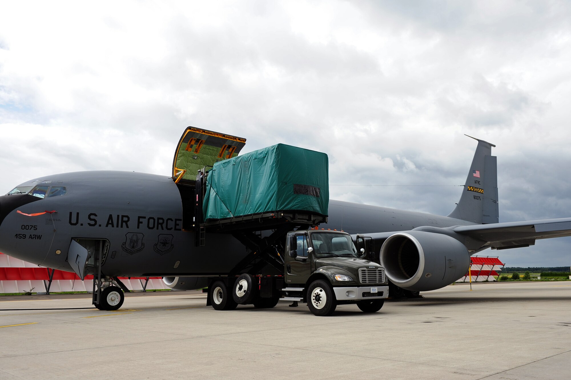U.S. Air Force service members from the 10th Expeditionary Aeromedical Evacuation Flight unload medical equipment from a KC-135 Stratotanker to a hi-lift after patients arrive at Ramstein Air Base, Germany, Aug. 8, 2011. The 10th EAEF received a high-lift from the 721st Aerial Port Squadron which enabled them to be more self-sufficient while transporting patients. (U.S. Air Force Photo by Airman 1st Class Brea Miller)