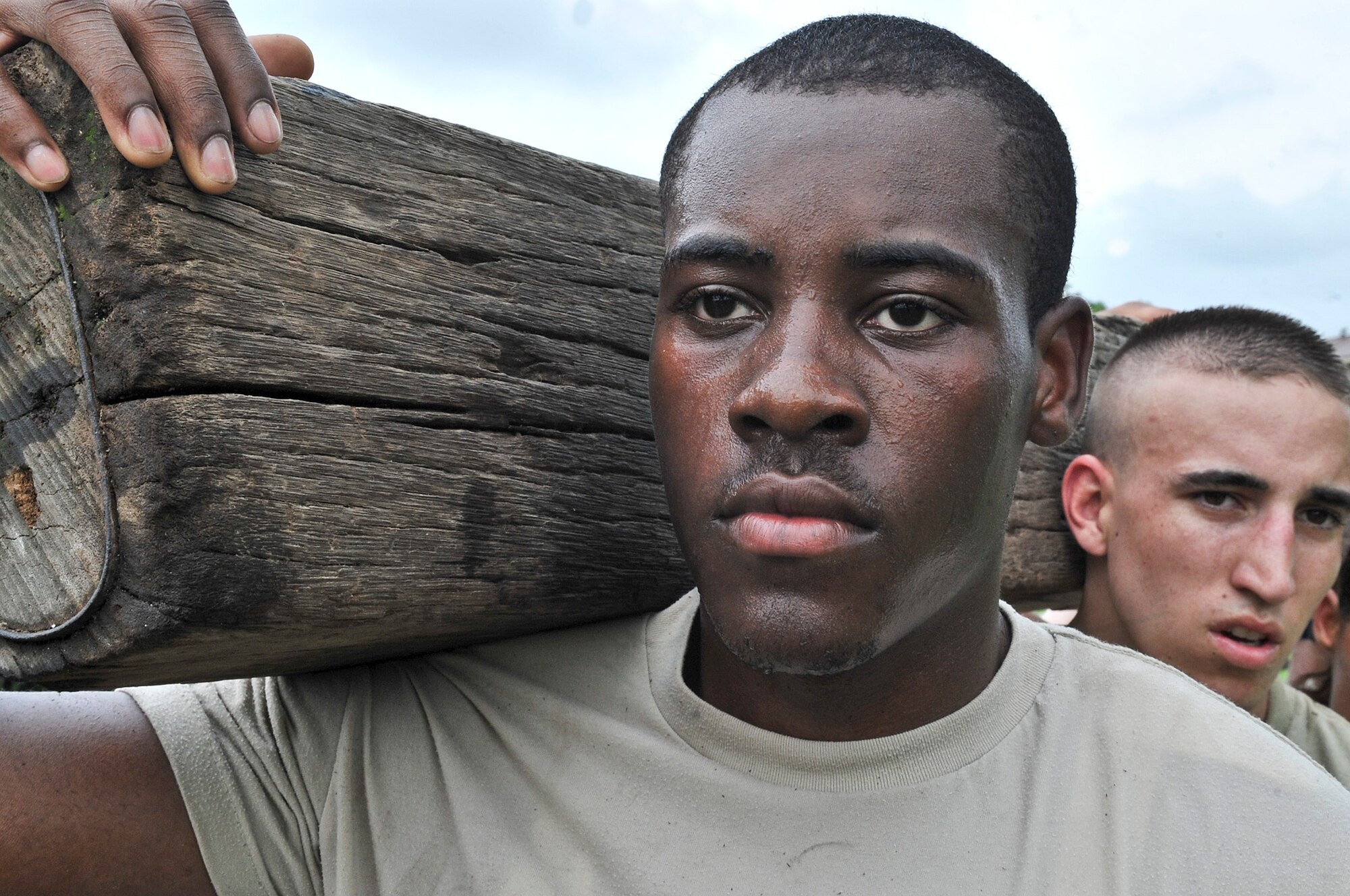 21 of the original 27 Airmen from the 51st Security Forces Squadron, who volunteered to try-out for the Quick Response Team, remain here, August 9. The Airmen were placed up against an elevated level of physical stress which tested not only their strength but also their capabilities to act as a cohesive squad. Throughout the day Airmen were also challenged to ensure the safety of on another while enduring the wear and tear of the physical portion of the tryouts. The Airmen were placed up against task such as completing a 5k as a squad while securing the 100 pound log over their shoulders, 4 sets of modified sit-ups, pushups and lunges which all were completed with the 100 pound log on the Airmen or being held by the Airmen with each set stopping at 31 in memory of the 31 warriors lost in Afghanistan, July 7. (U.S. Air Force Photos by/ Senior Airman Adam Grant)
