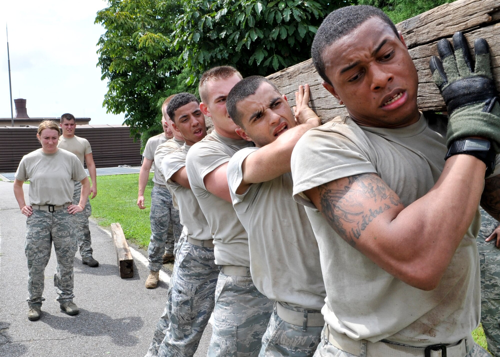 21 of the original 27 Airmen from the 51st Security Forces Squadron, who volunteered to try-out for the Quick Response Team, remain here, August 9. The Airmen were placed up against an elevated level of physical stress which tested not only their strength but also their capabilities to act as a cohesive squad. Throughout the day Airmen were also challenged to ensure the safety of on another while enduring the wear and tear of the physical portion of the tryouts. The Airmen were placed up against task such as completing a 5k as a squad while securing the 100 pound log over their shoulders, 4 sets of modified sit-ups, pushups and lunges which all were completed with the 100 pound log on the Airmen or being held by the Airmen with each set stopping at 31 in memory of the 31 warriors lost in Afghanistan, July 7. (U.S. Air Force Photos by/ Senior Airman Adam Grant)