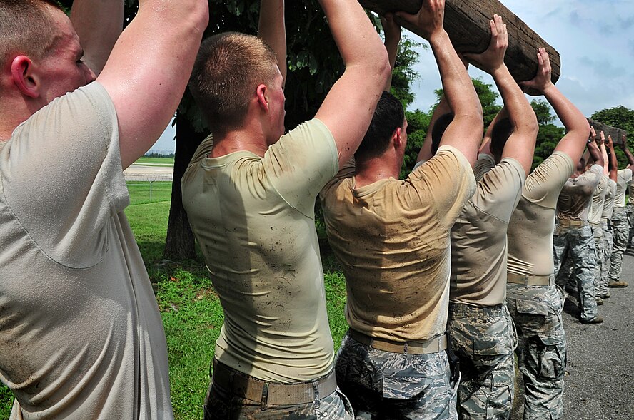 21 of the original 27 Airmen from the 51st Security Forces Squadron, who volunteered to try-out for the Quick Response Team, remain here, August 9.Day one of the QRT training, rigorous physical training continued as obstacles increased with difficulty testing [their] strength, hand-eye coordination and communications skills. SF Airmen participated in a 5k, securing 100 pound log carried as a squad, modified push-ups and sit-ups securing the log, clearing buildings, squad communication and tactical troop movements. Physical training sessions were themed in memory of the 31 warriors lost in Afghanistan, July 7, by each volunteer completing 31 of each exercise throughout the course. A QRT member provides immediate response to any high risk situation on Osan Air Base to include barricaded suspects, workplace violence, domestic violence and abuse response, school violence, and disaster response.  (U.S. Air Force Photo By/Staff Sgt. Daylena Gonzalez)

