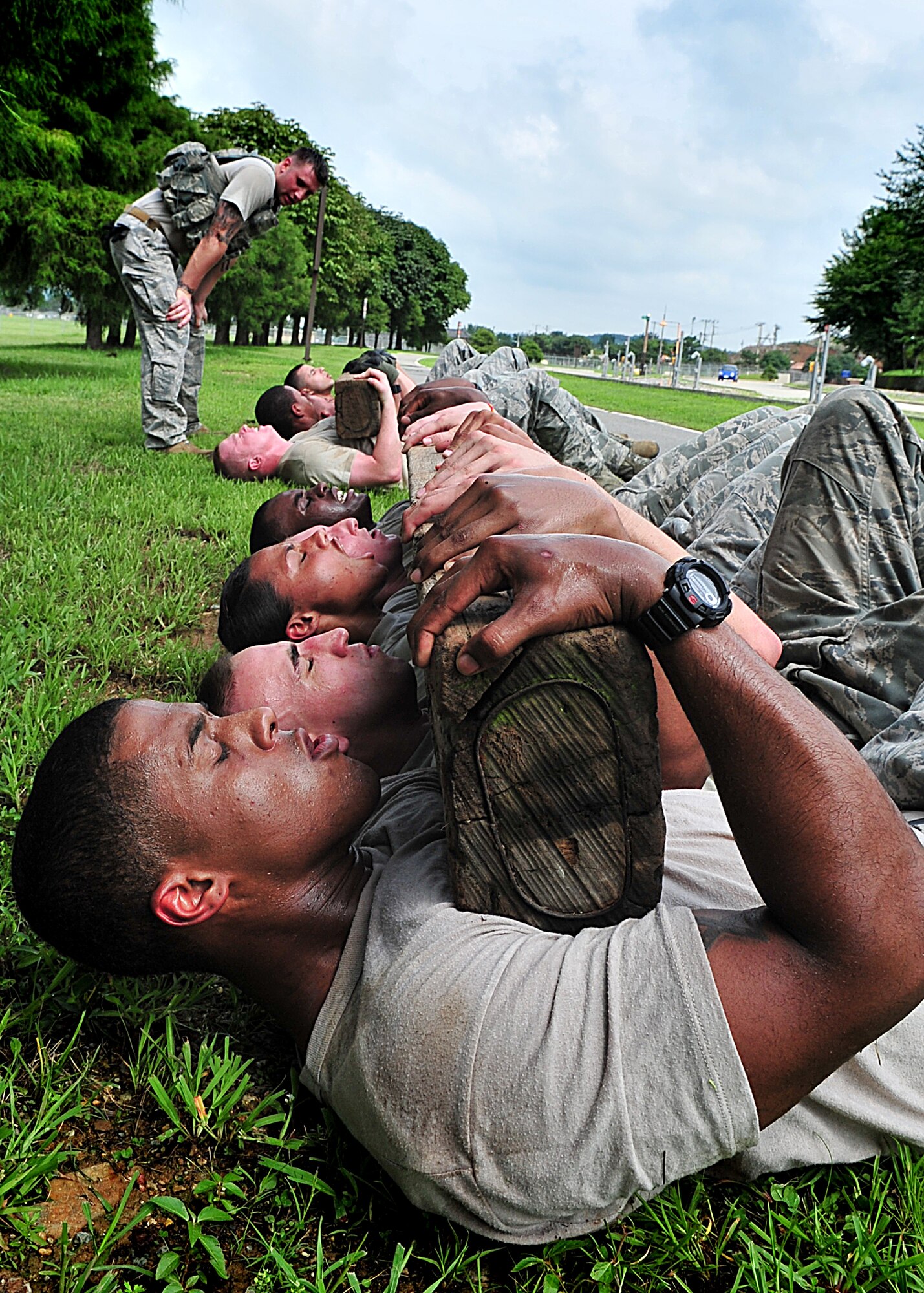 21 of the original 27 Airmen from the 51st Security Forces Squadron, who volunteered to try-out for the Quick Response Team, remain here, August 9.Day one of the QRT training, rigorous physical training continued as obstacles increased with difficulty testing [their] strength, hand-eye coordination and communications skills. SF Airmen participated in a 5k, securing 100 pound log carried as a squad, modified push-ups and sit-ups securing the log, clearing buildings, squad communication and tactical troop movements. Physical training sessions were themed in memory of the 31 warriors lost in Afghanistan, July 7, by each volunteer completing 31 of each exercise throughout the course. A QRT member provides immediate response to any high risk situation on Osan Air Base to include barricaded suspects, workplace violence, domestic violence and abuse response, school violence, and disaster response.  (U.S. Air Force Photo By/Staff Sgt. Daylena Gonzalez)
