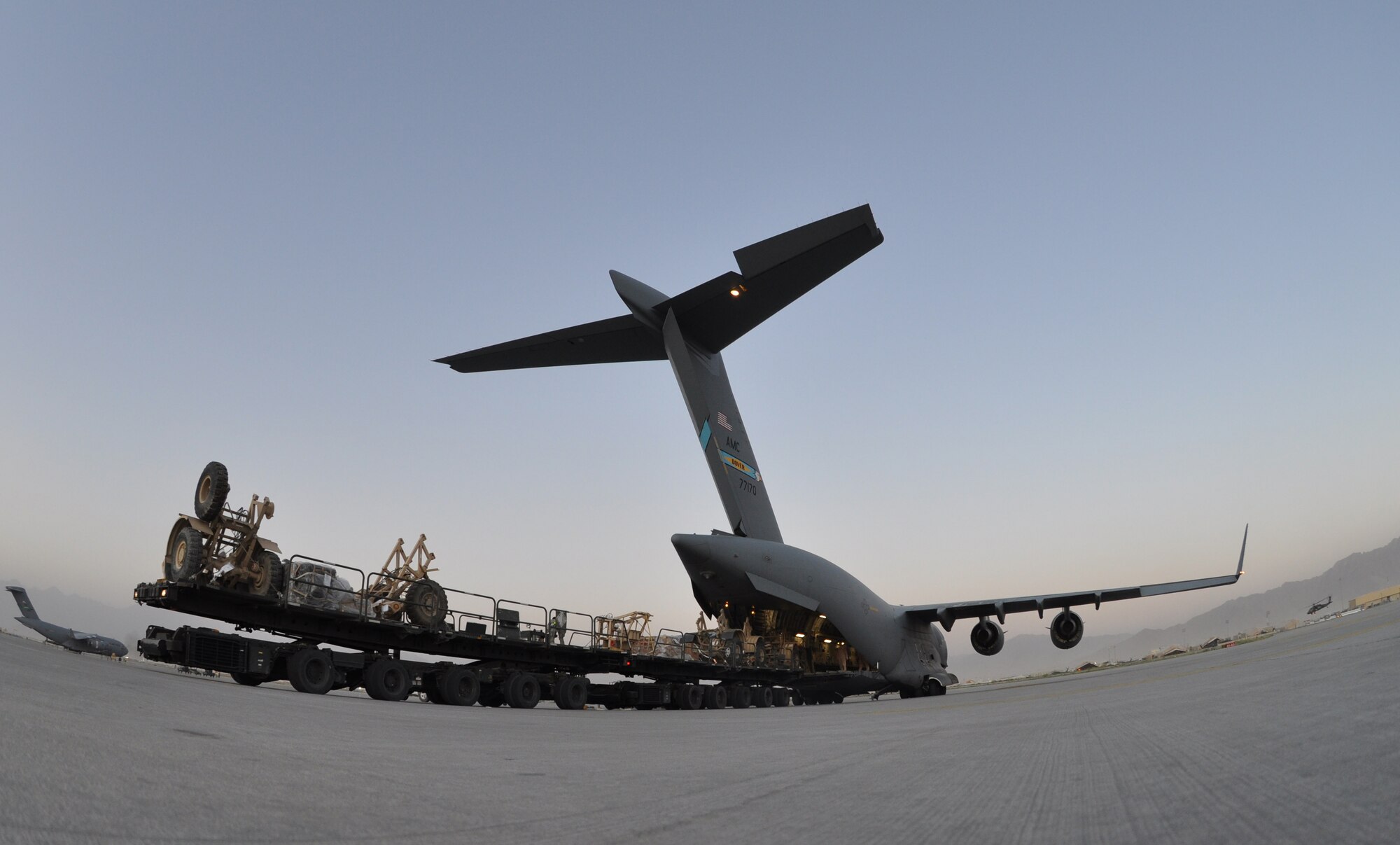 BAGRAM AIRFIELD, Afghanistan -- BAGRAM AIRFIELD, Afghanistan -- Airmen from the 455th Expeditionary Aerial Port Squadron load a C-17 Globemaster III with cargo here August 1, 2011. The 455 EAPS’s mission is moving passengers and cargo all throughout Afghanistan. More than 80 percent of all people and supplies traveling through the country come through 455 EAPS. (U.S. Air Force photo/Capt. Korry Leverett)