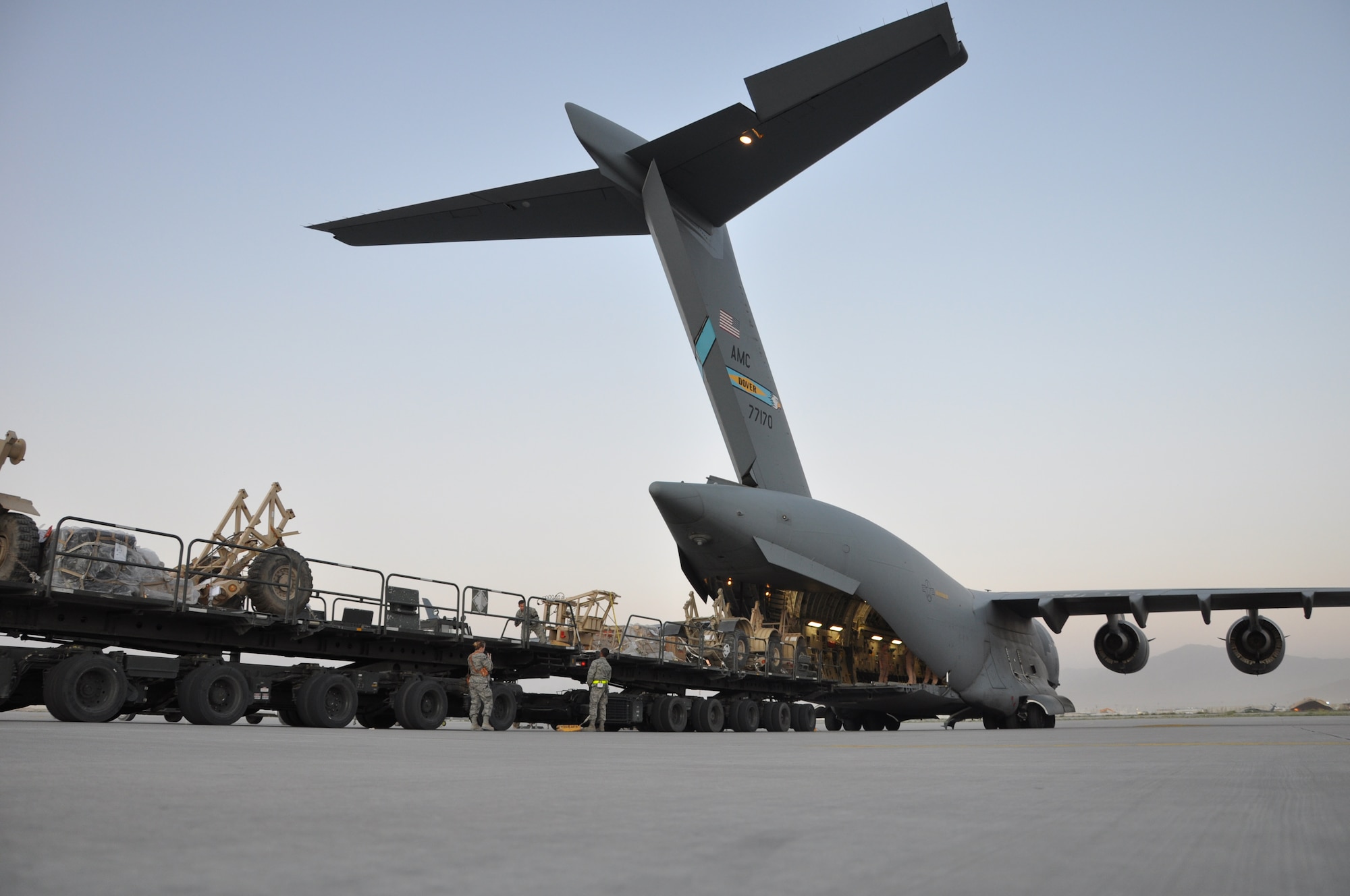 BAGRAM AIRFIELD, Afghanistan -- Airmen from the 455th Expeditionary Aerial Port Squadron load a C-17 Globemaster III with cargo here August 1, 2011. The 455 EAPS’s mission is moving passengers and cargo all throughout Afghanistan. More than 80 percent of all people and supplies traveling through the country come through 455 EAPS. (U.S. Air Force photo/Capt. Korry Leverett)