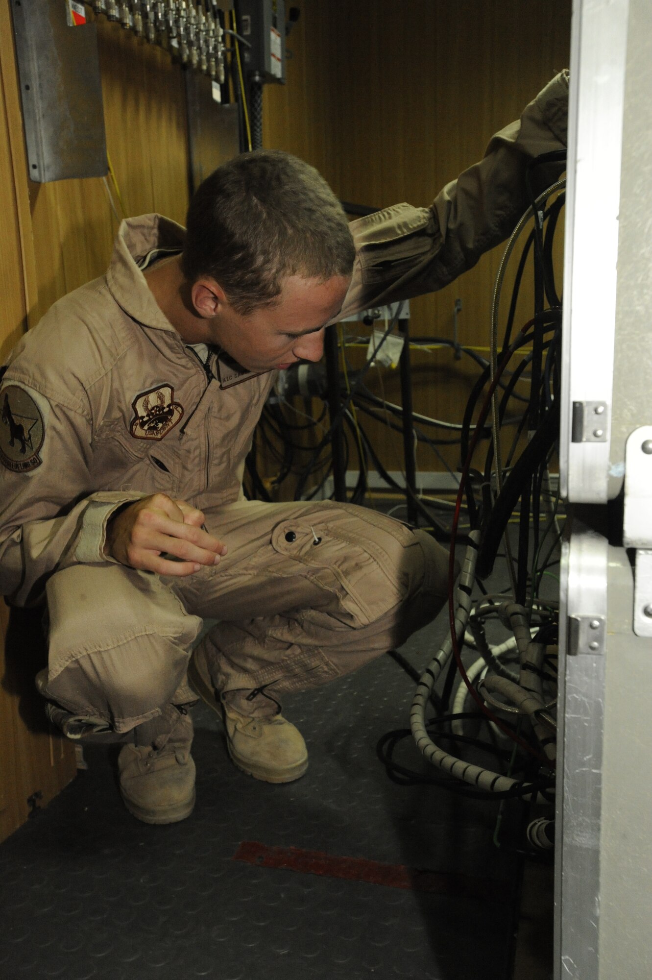 Airman 1st Class Cameron Bilyeu checks the roll-on, beyond-line-of-sight enhancement system to ensure the cabling is correct during a training session at the Transit Center at Manas, Kyrgyzstan, Aug. 5. The ROBE system enhances the military's overall battlefield command and control communication ability. Bilyeu is deployed to the 22nd Expeditionary Air Refueling Squadron as a boom operator. He is deployed here from Fairchild Air Force Base, Wash. (U.S. Air Force photo/Tech. Sgt. Tammie Moore)