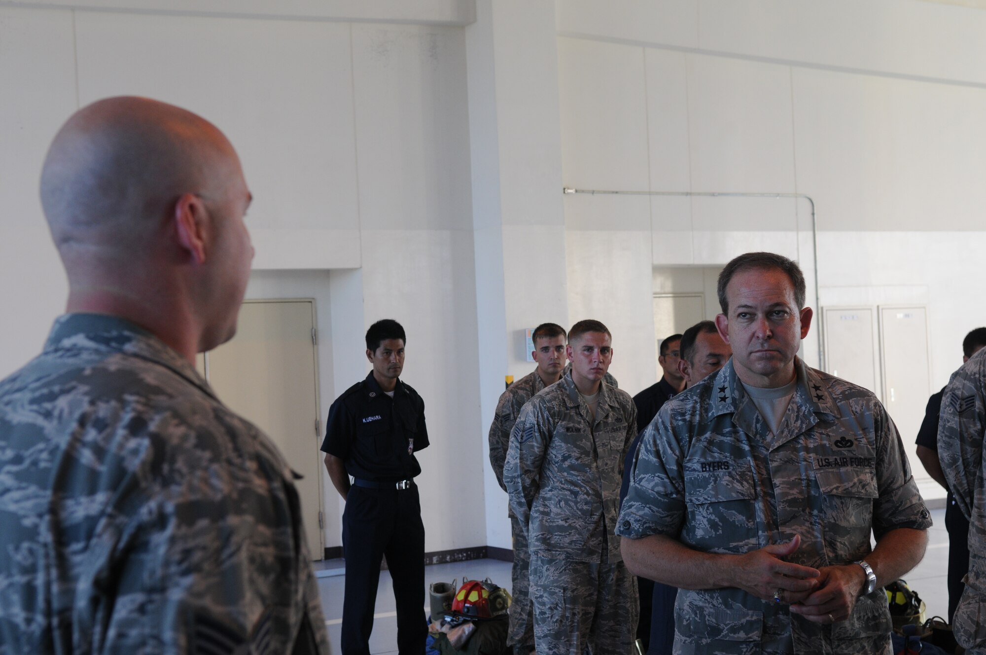 Maj. Gen. Timothy A. Byers, Air Force Civil Engineer, listens intently at morning roll call as Tech. Sgt. Jeffrey Ruffenach, 18th Civil Engineer Squadron fire inspector, describes challenges facing today's Air Force firefighters during Byer's visit to Kadena Air Base, Japan, in July. Kadena operates a total of four fire stations which support more than 100 permanently assigned and attached aircraft, 9,000 facilities, and a population of 25,000 personnel. (U.S. Air Force photo/Airman 1st Class Jarvie Z. Wallace)