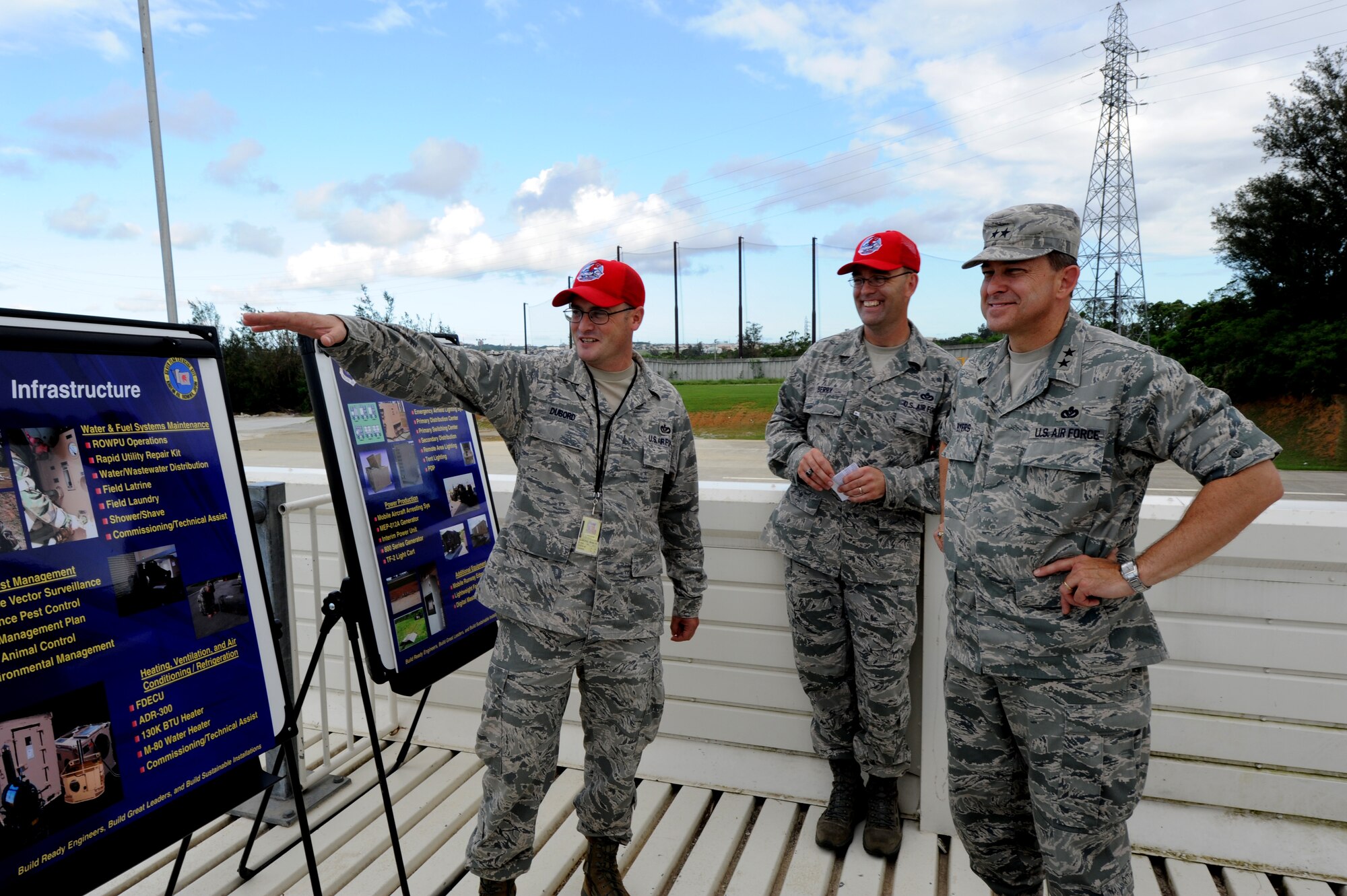 Tech. Sgt. Brian Dubord, 554th RED HORSE Squadron Detachment 1 Water and Fuel Systems contingency training NCO in charge, and Chief Master Sgt. Garry Berry II, 554th RED HORSE Squadron Detachment 1 chief enlisted manager, provide Maj. Gen. Timothy A. Byers, Air Force Civil Engineer, an overview of the Pacific Air Forces Silver Flag training site during Byers' visit to Kadena Air Base, Japan, in July. The Silver Flag site hosts approximately 1,200 students annually from various Air Force installations throughout PACAF. (U.S. Air Force photo/Airman 1st Class Jarvie Z. Wallace)