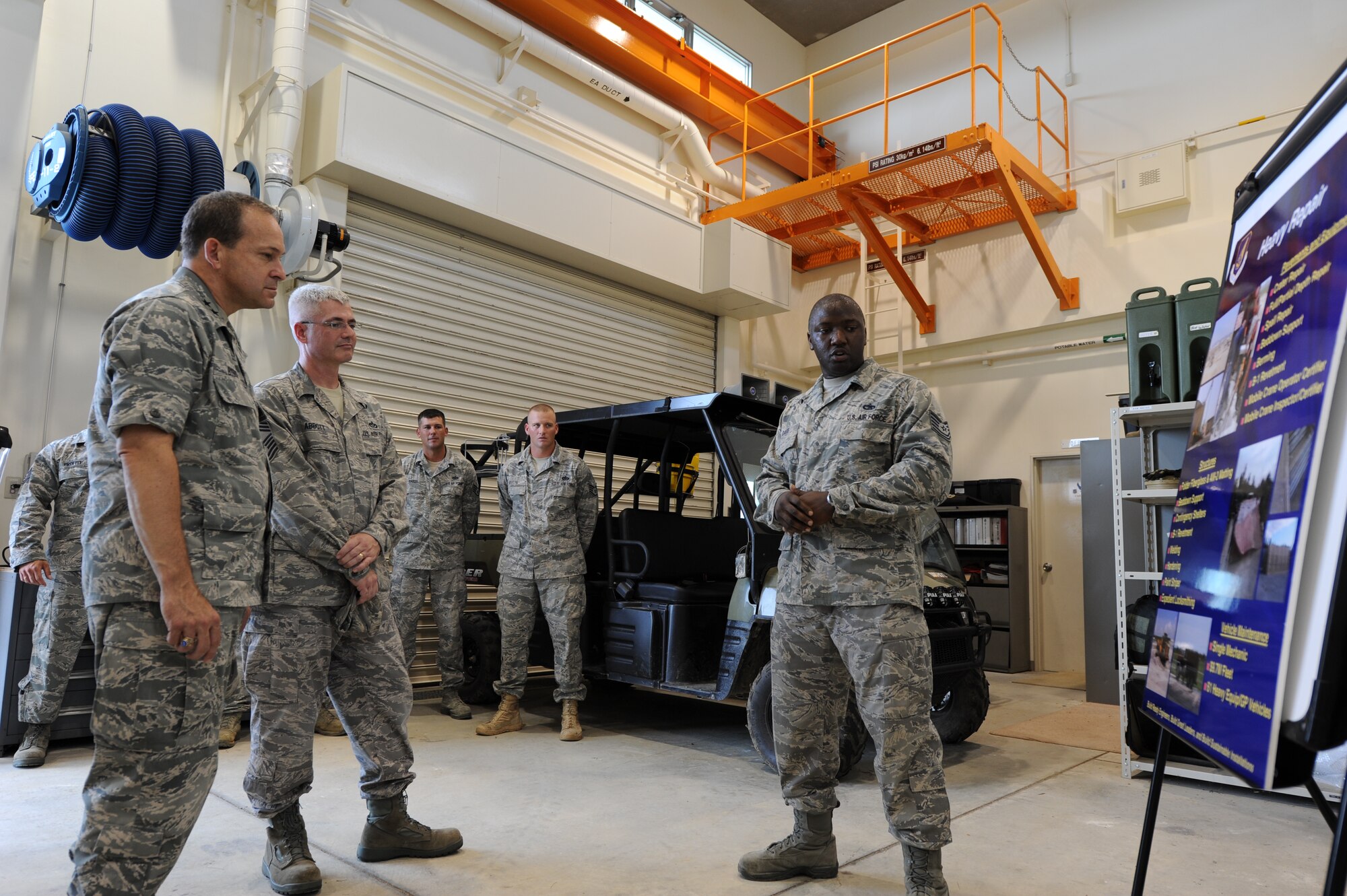 Tech. Sgt. Albert Davis Jr., 554th RED HORSE Squadron Detachment 1 Vehicle Maintenance NCO in charge, describes rapid runway repair techniques and procedures taught at Pacific Air Force's Silver Flag exercise site to Maj. Gen. Timothy A. Byers, Air Force Civil Engineer, and Chief Master Sgt. Pat Abbott, Office of the Civil Engineer, chief of enlisted matters, during Byers' and Abbott's visit to Kadena Air Base, Japan, in July. (U.S. Air Force photo/Airman 1st Class Jarvie Z. Wallace)