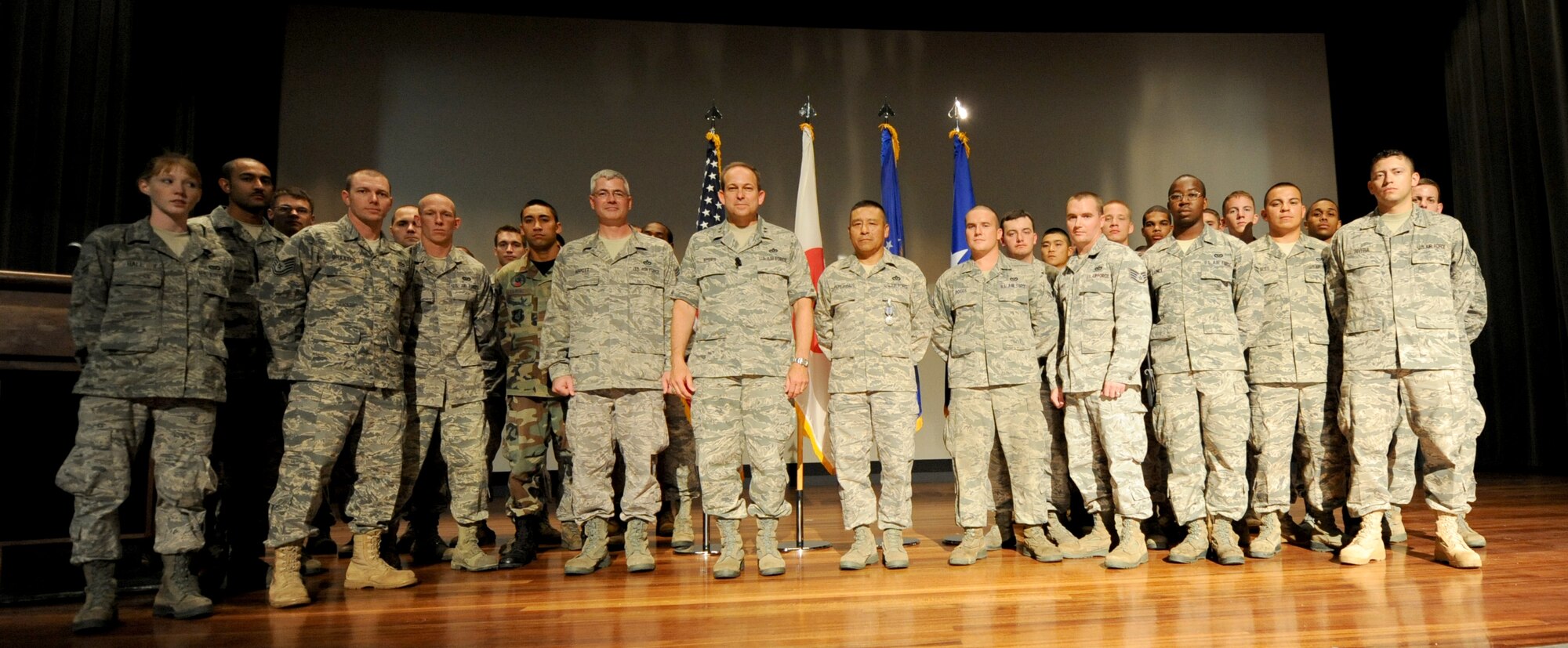 Maj. Gen. Timothy A. Byers, Air Force Civil Engineer, and Chief Master Sgt. Pat
Abbott, Office of the Civil Engineer, chief of enlisted matters, present Air Force Achievement medals to members of the 18th Civil Engineer Group and 554th RED HORSE Squadron Detachment 1 during Byers' and Abbot's visit to Kadena Air Base, Japan, in July. The medals were presented to the Airmen for their efforts to support recovery operations at Misawa Air Base and other locations in northern Japan as part of Operation Tomodachi. (U.S. Air Force photo/Airman 1st Class Jarvie Z. Wallace)