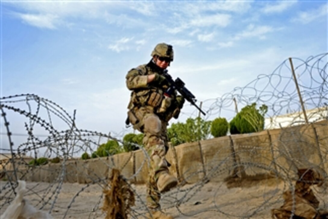 U.S. Air Force Airman 1st Class Steven Armenta patrols through Qalat City, Afghanistan, on Aug. 9, 2011.  Armenta is a member of Provincial Reconstruction Team Zabul's security force.   