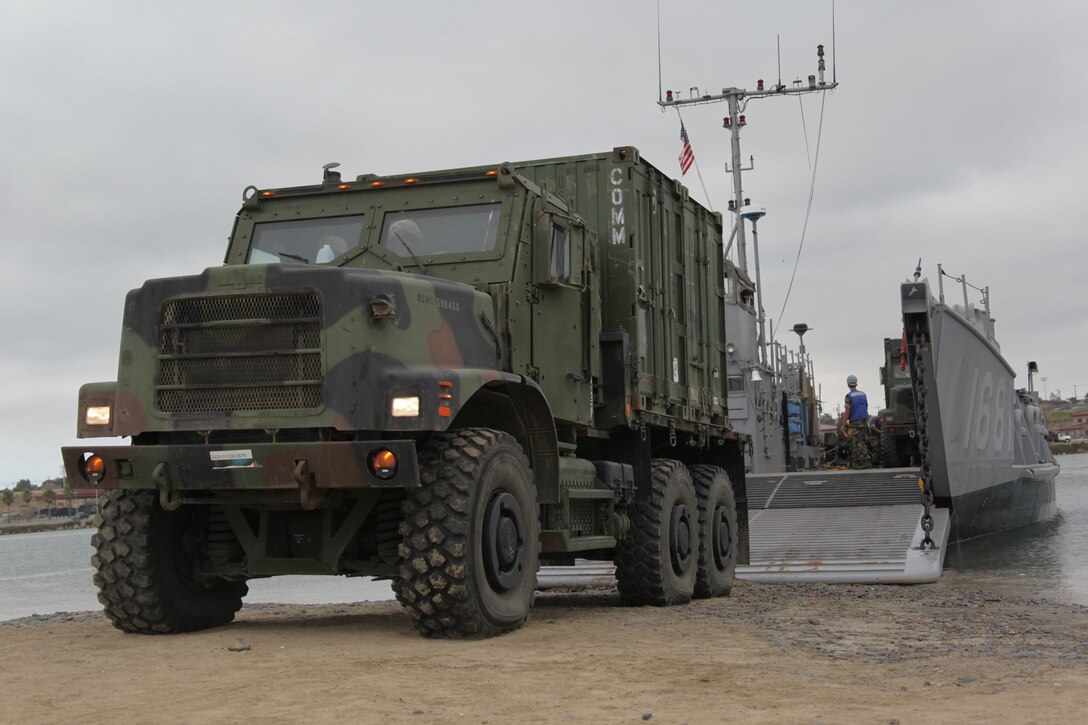 Marines and sailors with Combat Logistics Battalion 11 and the Navy's Amphibious Squadron 5 off-load a truck from a landing craft here Aug. 10. The battalion is the logistics combat element for the 11th Marine Expeditionary Unit, which began a sea-based exercise Aug. 10, its first aboard amphibious ships since becoming a complete Marine air-ground task force in May.