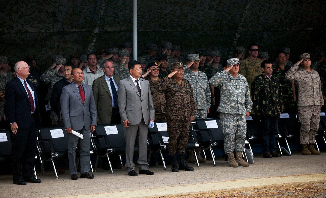 Distinguished guests salute during the national anthem of Mongolian at the closing ceremony of Exercise Khaan Quest 2011 at Five Hills Training Area near Ulaanbaatar, Mongolia, Aug. 12. Khaan Quest is a training exercise designed to strengthen the capabilities of U.S., Mongolian and other participating nations’ forces in international peace support operations and civic outreach programs worldwide.