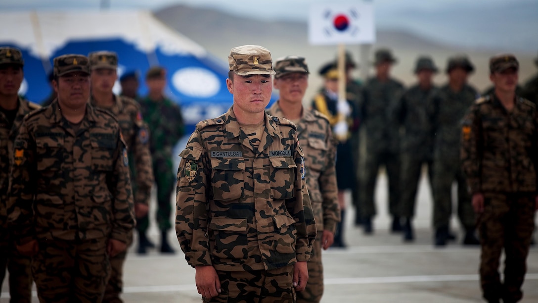 Members of the Mongolian armed forces stand at position of attention as Lt. Gen. Ts. Bayambajav, chief of general staff, MAF, addresses them during the closing ceremony of Exercise Khaan Quest 2011 at Five Hills Training Area near Ulaanbaatar, Mongolia, Aug. 12. Khaan Quest is a training exercise designed to strengthen the capabilities of U.S., Mongolian and other participating nations’ forces in international peace support operations and civic outreach programs worldwide.