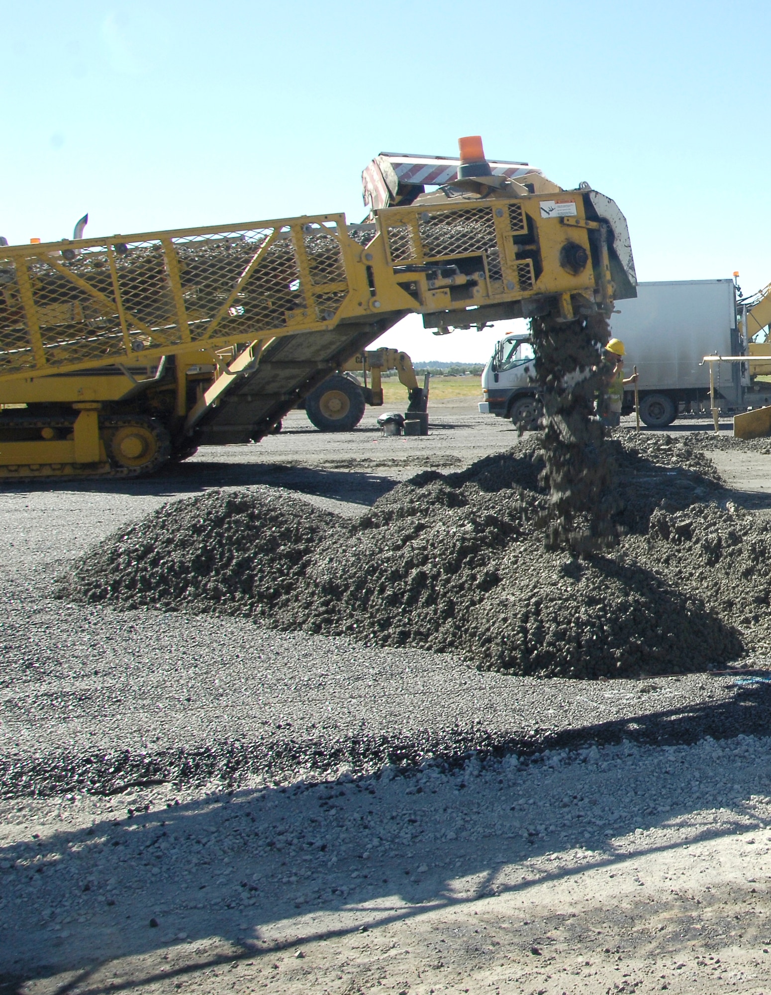 A placer places crushed concrete consistently to help build Fairchild’s new runway. The concrete is moist when it comes off the placer’s belt to help compose material.  (U.S. Air Force photo/Airman 1st Class Earlandez Young)