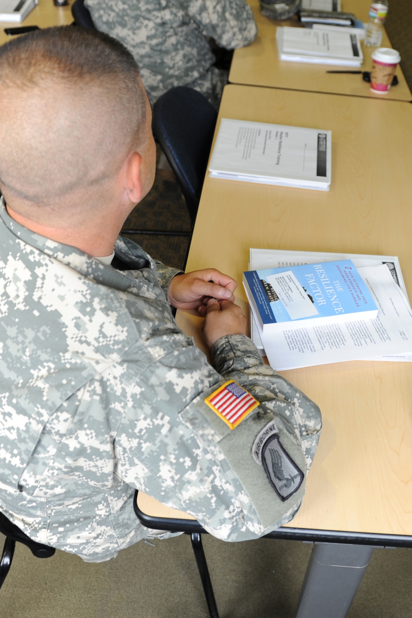 Army Sgt. Frank Bateman, U.S. Army Alaska, listens to an introduction to the two-week Master Resilience Trainer program at the Joint Base Elmendorf-Richardson Education Center, Aug. 8, 2011. Seventy-three Soldiers, Airmen and civilians will spend 80 class
hours learning how to teach resilience techniques to their respective units. (U.S. Air Force photo/Luke Waack)