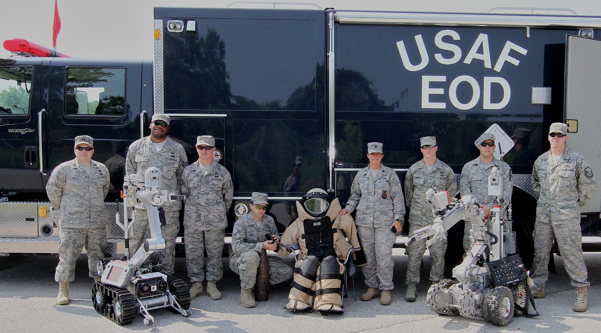 The 932nd Civil Engineer Squadron (Explosive Ordance Disposal) team poses with their truck, robots and protective suit.  The 932nd Airlift Wing, Air Force Reserve, flies the C-40C and C-9C aircraft. (U.S. Air Force photo/Tech. Sgt. Christopher Parr) 