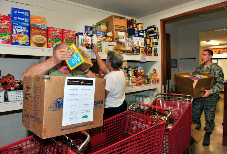 Master Sgt. Collin Baulch carries a box of donated food into the Community Interfaith Food Pantry in Belleville Ill., Aug. 5, 2011. The pantry is receiving donated items from people at nearby Scott Air Force Base during August as part of the Department of Defense “Feds Feeds Families” campaign. Food banks across the country are facing severe shortages of non-perishable items while children are left without school nutrition programs in the summer months. (U.S. Air Force photo/ Staff Sgt. Stephenie Wade)