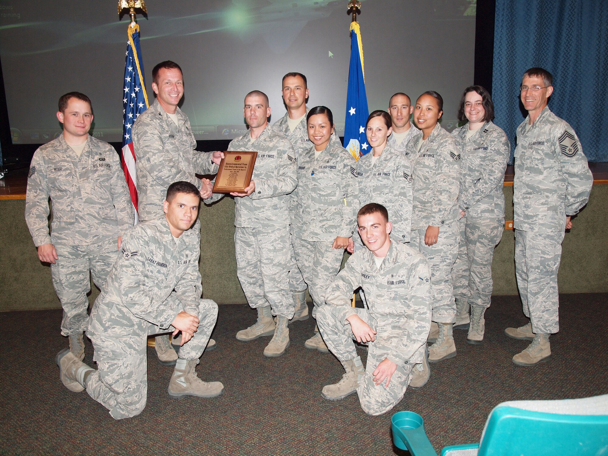 Col. Bruce Roehm, 341st Medical Group commander, presents the Bioenvironmental Engineering Element with their quarterly Medical Group Team award during the Group's commander's call July 28.  (Courtesy photo)