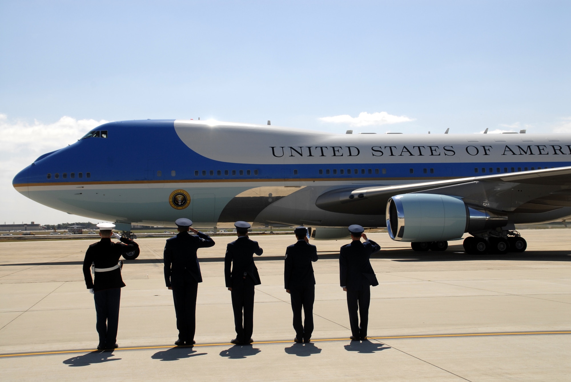 WRIGHT-PATTERSON AIR FORCE BASE, Ohio - Second from left, Senior Airman Tony Eubanks, 87th Aerial Port Squadron, salutes Air Force One as it departs Joint Base Andrews, Md., during his annual tour in June. (U.S. Air Force photo/Master Sgt. Charlie Miller)