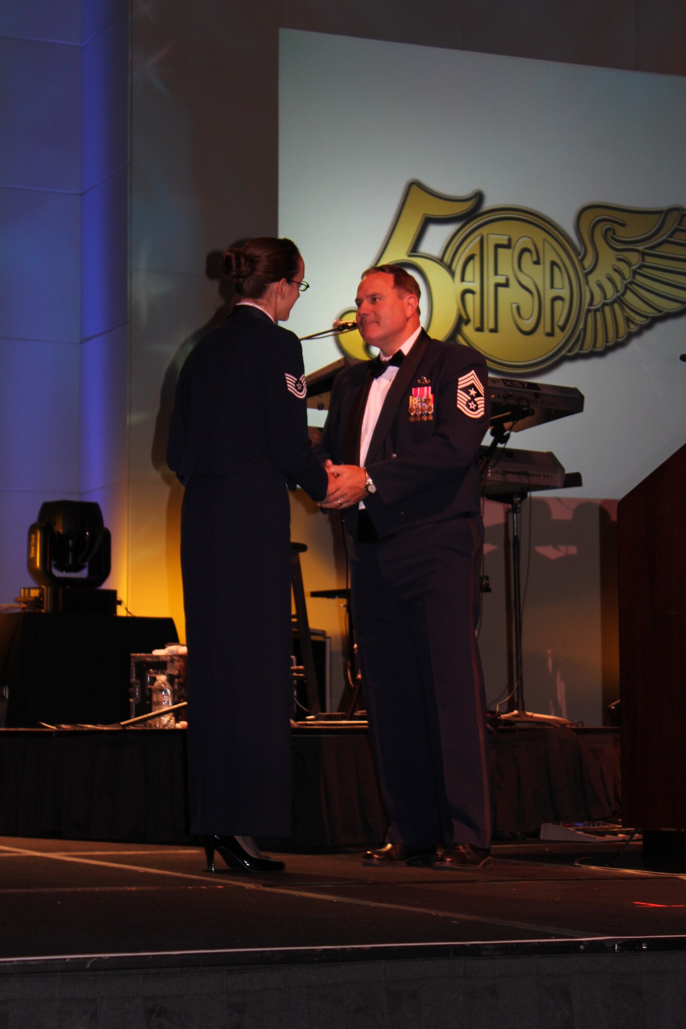 Tech. Sgt. Jessica Mohney, 87th Force Support Squadron, receives a Plaque of Appreciation from retired Chief Master Sgt. Jeffrey Ledoux, Air Force Sergeant Association International president, during the 2011 Professional Airmen Conference's Chief Master Sgt of the Air Force Annual Awards Banquet in San Antonio, Texas. Mohney is an active member of AFSA at Joint Base McGuire-Dix-Lakehurst. (Courtesy photo/Released)