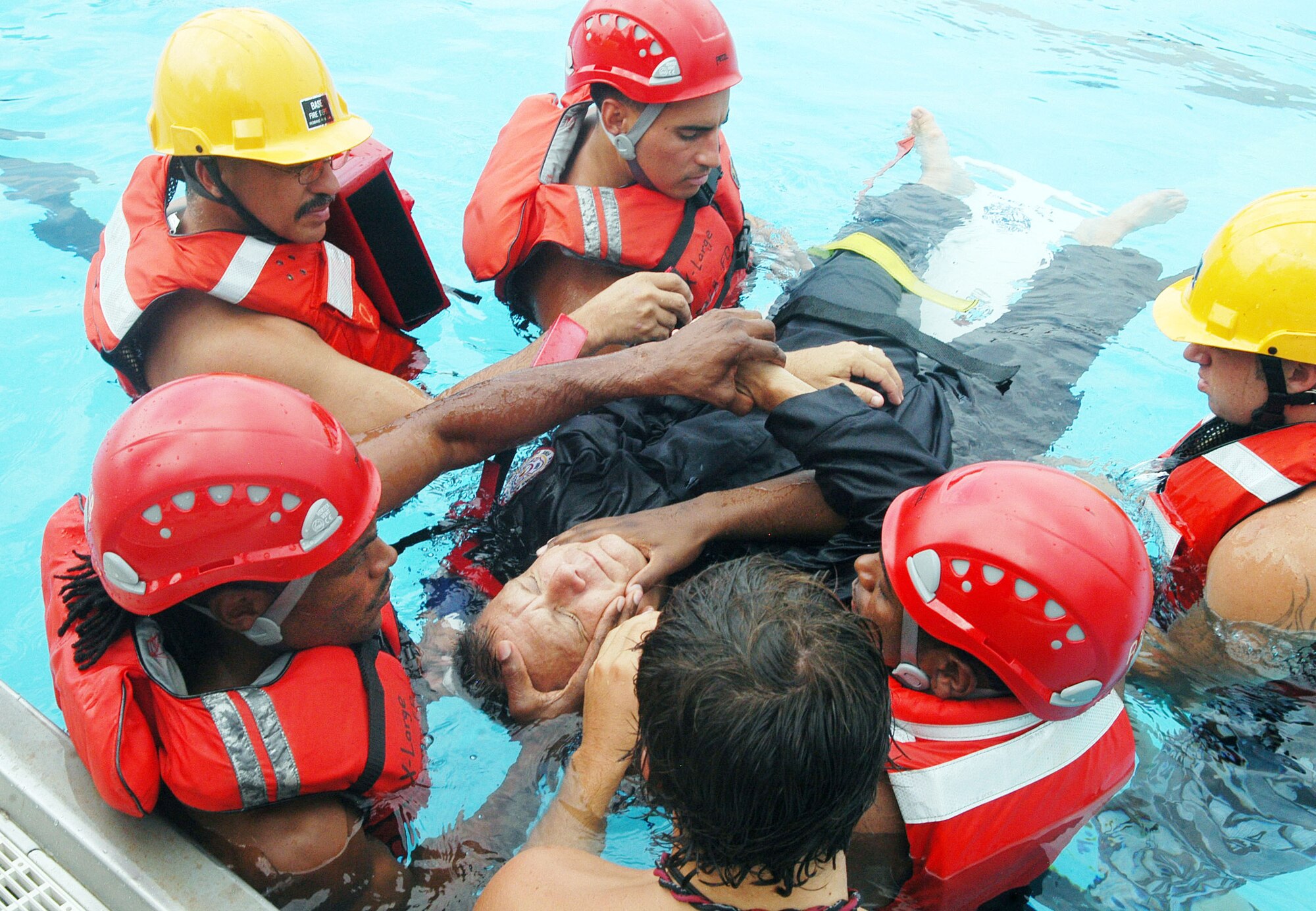 Robins firefighters were taught the proper way to strap a victim onto a spine board for safe removal from water. U. S. Air Force photo by Sue Sapp