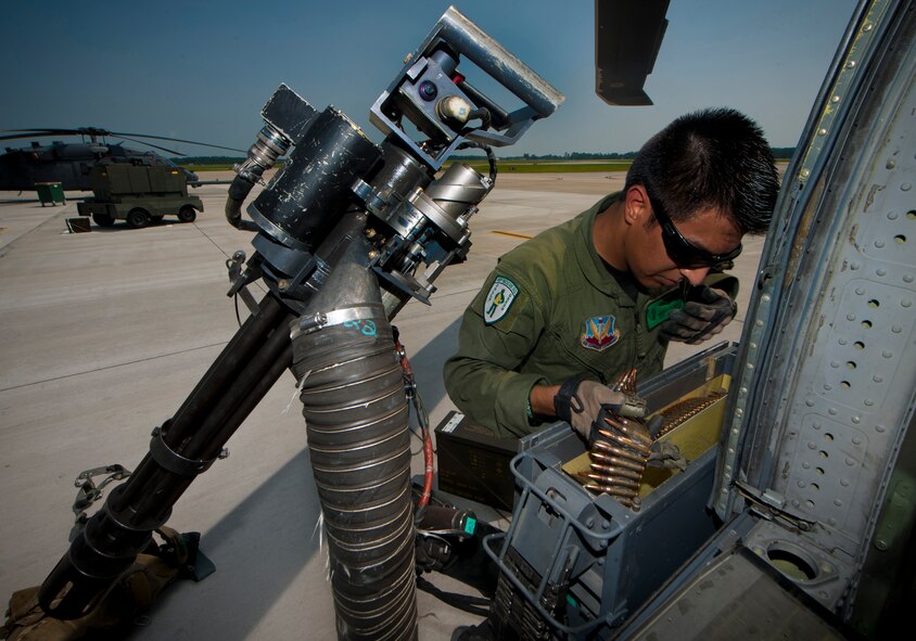 U.S. Air Force Airman 1st Class Henry Flores, 41st Rescue Squadron aerial gunner, loads rounds into a GAU-2/A 7.62mm minigun during a pre-flight inspection at Moody Air Force Base, Ga., Aug. 3, 2011. The minigun is a multi-barrel heavy machine gun with a high rate of fire from 2,000 to 6,000 rounds per minute. (U.S. Air Force photo by Airman 1st Class Joshua Green/Released)
