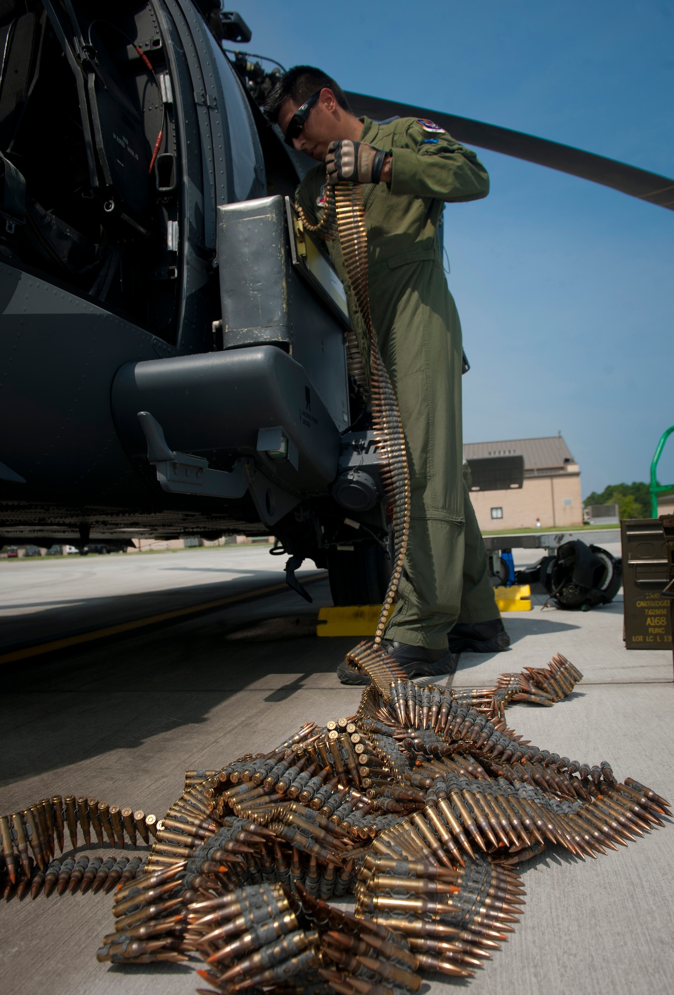 U.S. Air Force Airman 1st Class Henry Flores, 41st Rescue Squadron aerial gunner, loads ammunition into an ammunition box at Moody Air Force Base, Ga., Aug. 3, 2011. Aerial gunners are tasked to thoroughly inspect the HH-60G Pave Hawk before every flight to ensure it’s mission ready. (U.S. Air Force photo by Airman 1st Class Joshua Green/Released)
