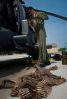 U.S. Air Force Airman 1st Class Henry Flores, 41st Rescue Squadron aerial gunner, loads ammunition into an ammunition box at Moody Air Force Base, Ga., Aug. 3, 2011. Aerial gunners are tasked to thoroughly inspect the HH-60G Pave Hawk before every flight to ensure it’s mission ready. (U.S. Air Force photo by Airman 1st Class Joshua Green/Released)
