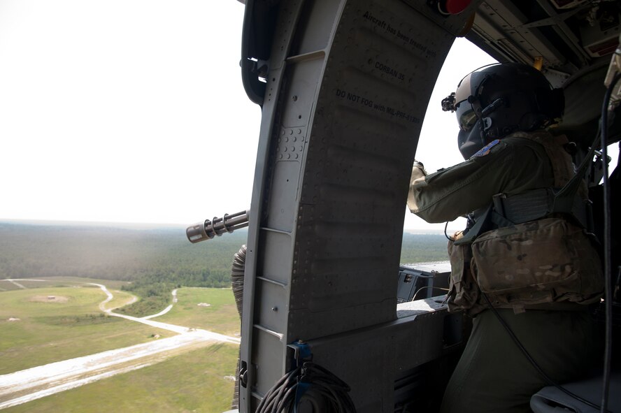 U.S. Air Force Airman 1st Class Henry Flores, 41st Rescue Squadron aerial gunner, engages pop-up targets at Grand Bay Bombing and Gunnery Range, Ga., Aug. 3, 2011. HH-60G Pave Hawk aerial gunners are tasked with protecting their crew at all costs by suppressing and neutralizing hostile forces. (U.S. Air Force photo by Airman 1st Class Jarrod Grammel/Released)
