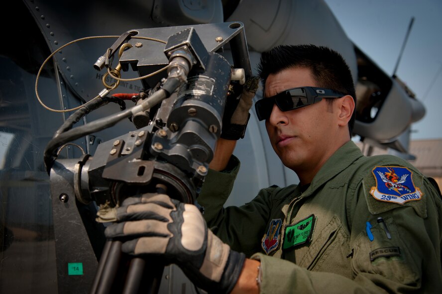 U.S. Air Force Airman 1st Class Henry Flores, 41st Rescue Squadron aerial gunner, inspects a GAU-2/A 7.62mm minigun during a pre-flight inspection at Moody Air Force Base, Ga., Aug. 3, 2011. Before taking off, aerial gunners thoroughly inspect their weapons and the aircraft to ensure it is mission-ready. (U.S. Air Force photo by Airman 1st Class Jarrod Grammel/Released)
