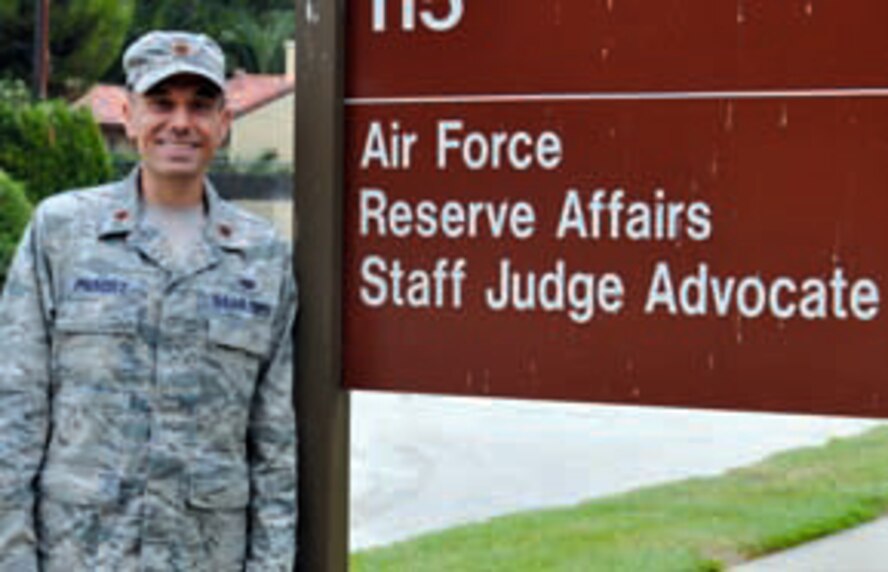 Maj. Deric Prescott posses for a photo outside the staff judge advocate office at March Air Reserve Base, July 14. Prescott took the place of Maj. Dale Riedel, who departed earlier this month for his new position at the Pentagon. (U.S. Air Force photo / Megan Crusher)
