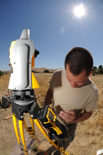 Staff Sgt. Tyler Davis, suveyor with the 126th Civil Engineering Squadron, checks information on a Trimble Total Station as his team does a topographical survey. The Illiinois Air National Guard unit is assisting the California Army National Guard in renovations at Camp Roberts, Cali. The Army National Guard training base was created in 1941 to support troops leaving for World War II and is now in need of repairs to buildings and infrastructure. Air National Guard Civil Engineering squadrons are using the opportunity to train on real world electrical, structural, plumbing and heavy equipment scenarios. This creates a  collaboration that proves valuable to both National Guard components. (U.S. Air Force photo by Master Sgt. Ken Stephens)