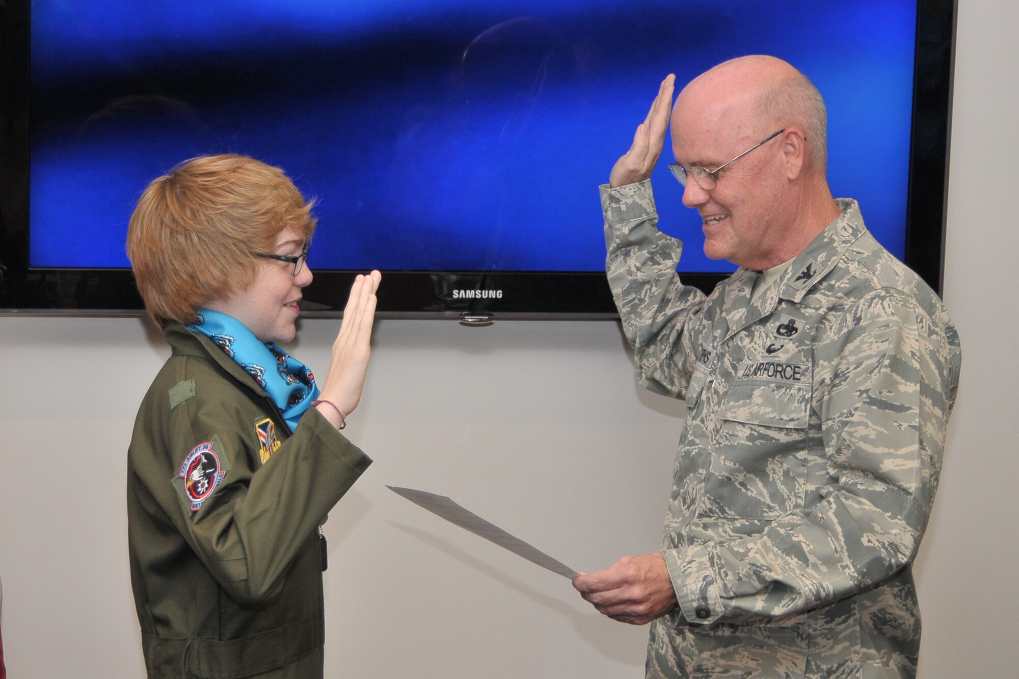 YOUNGSTOWN AIR RESERVE STATION, Ohio -- Air Force Reserve Col. Dale Andrews (right), commander of the 910th Maintenance Group, swears in 15-year old Connor Covan, of nearby Boardman, Ohio, as an honorary second lieutenant as part of the wing's 45th Pilot for a Day (PFAD) program held here, August 10, 2011. Connor is currently receiving treatment for Juvenile Rheumatoid Arthritis and Brugada Syndrome at Akron Children's Hospital of the Mahoning Valley, also in Boardman. The purpose of the PFAD program is to reach out to the community by providing a day of activities to children who live with a chronic or life-threatening disease or illness. U.S. Air Force photo by Tech. Sgt. James Brock.
 