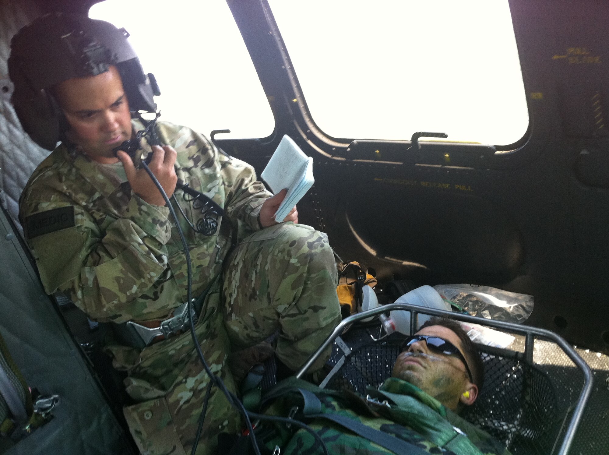 Tech. Sgt. Joseph Brownell, an independent duty medical technician, monitors 1st Lt. Andrew Metzger, Survival Evasion Resistance Escape student, following Metzger’s reaction to a bee sting while he was in training. The four-man crew helped to rescue Metzger by airlifting him from the Colville National Forest, Wash., to Sacred Heart Medical Center in Spokane, Wash. (Courtesy photo)   