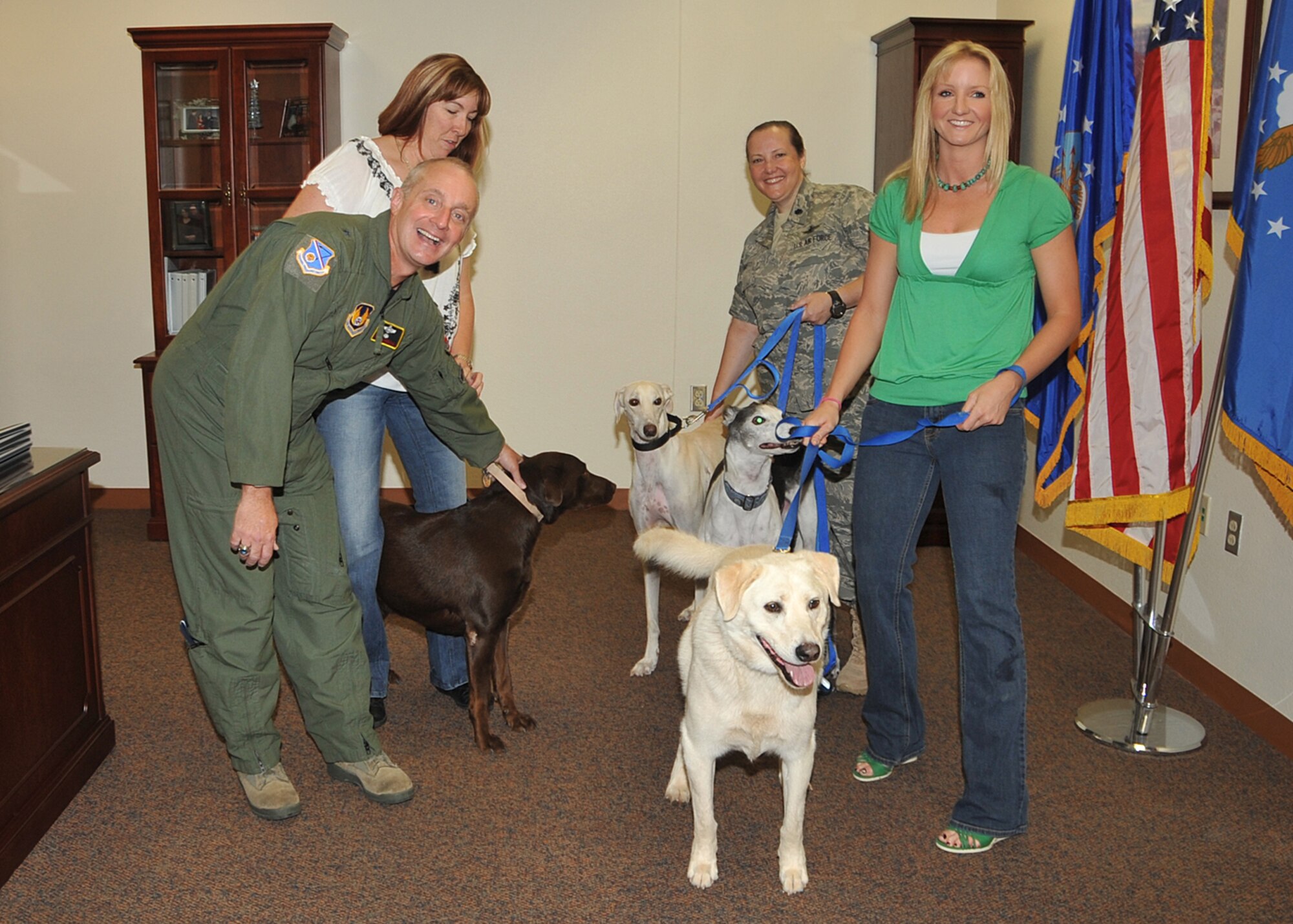 Brig. Gen. Garrett Harencak, left, Air Force Nuclear Weapons Center commander, along with Wendy Sawyer, back left, of Luvin Labs, Lt. Col. Laura Garrett, 498th Nuclear Systems Wing, right center, and Jessica Zeman, 498 NSW, meet several dogs Aug. 5 as part of Operation Doggie Treats. Base members and their pets are invited to attend “Operation Doggie Treats” Aug. 20 sponsored by the Team Kirtland Junior Force Council. Luvin’ Labs is a Labrador Retriever rescue with the Animal Humane Association of New Mexico.

Photo by Todd Berenger
