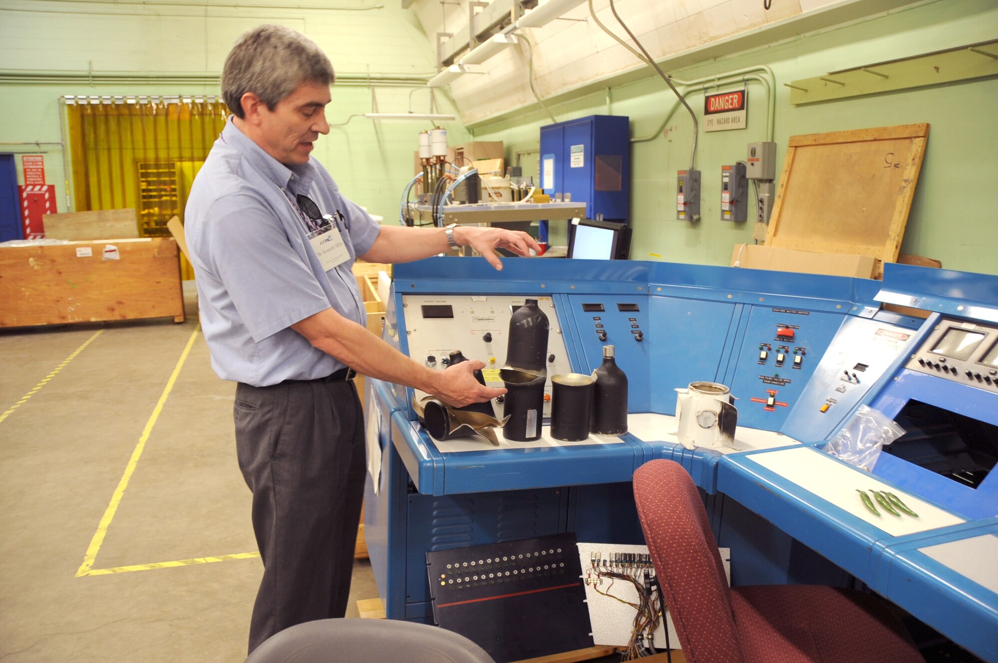 Kenneth Miller, AFRL, talks about various objects that were cut by laser beams.

Photo by Dennis Carlson
